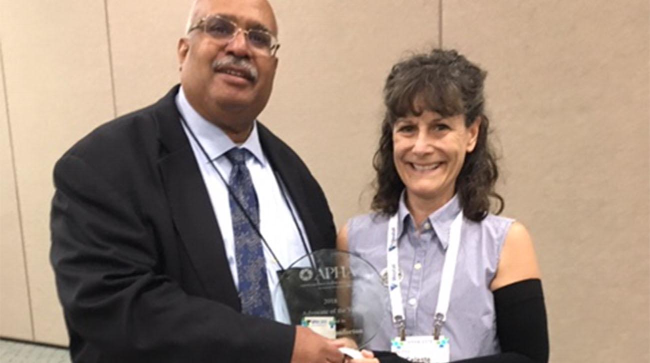 Dr. Celeste Monforton (right) accepts APHA Advocate of the Year Award