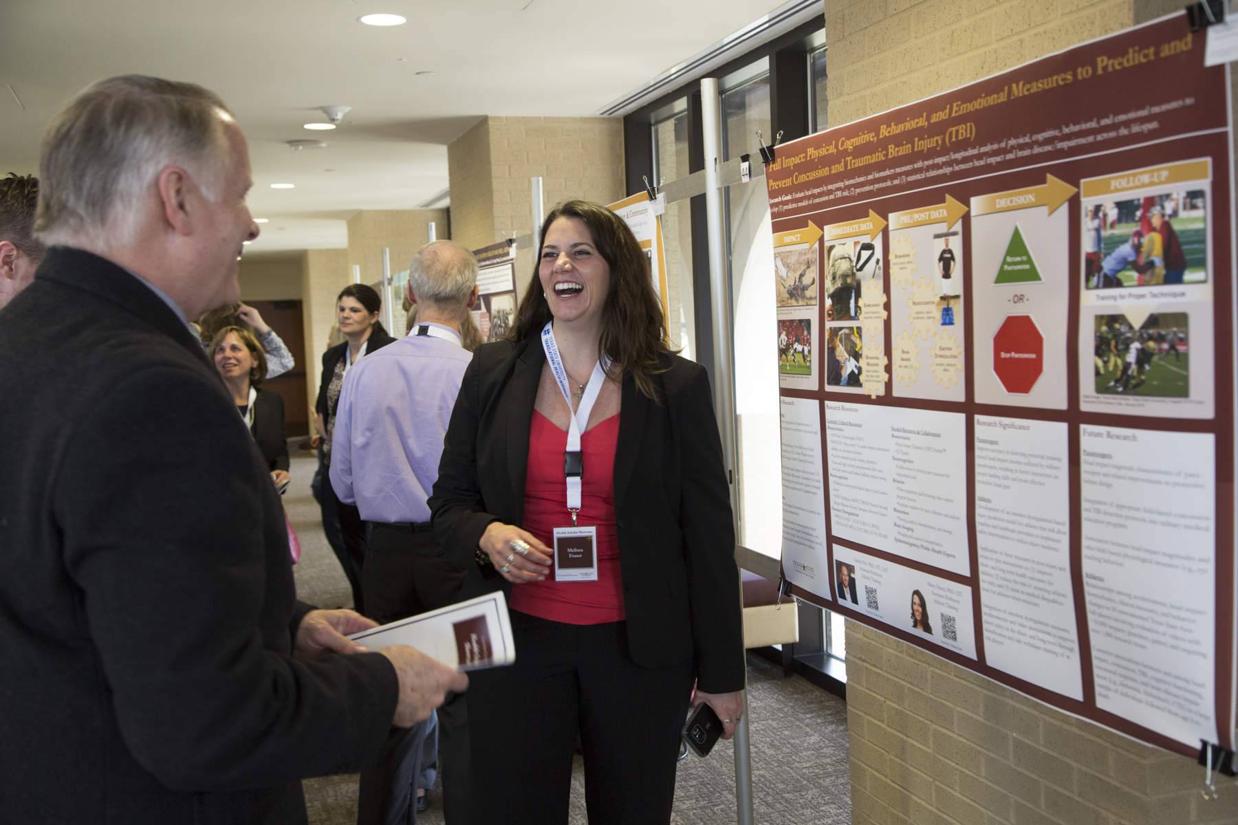 HHP Assistant Professor Missy Fraser discusses her Concussion Research with Health Scholars Showcase attendee