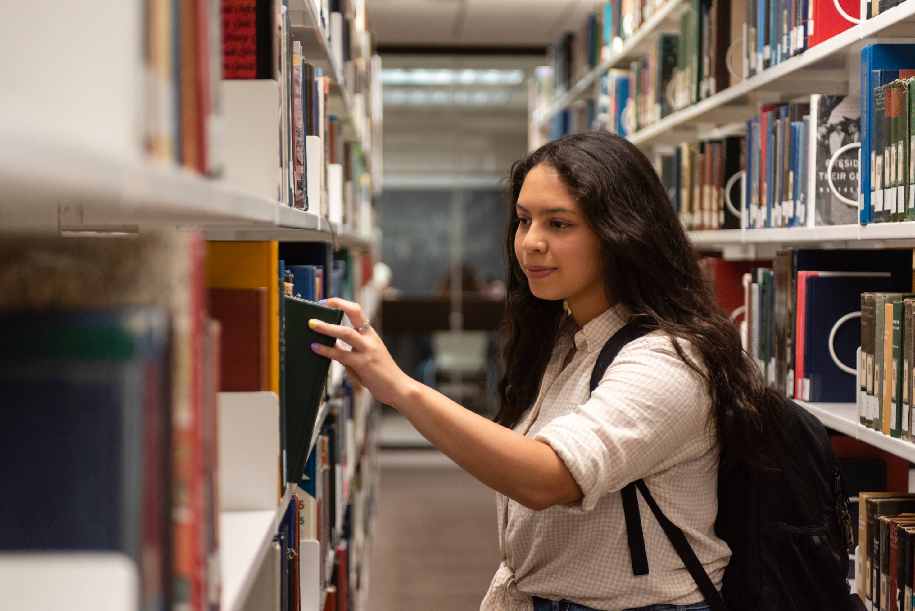 Girl checking out book at library