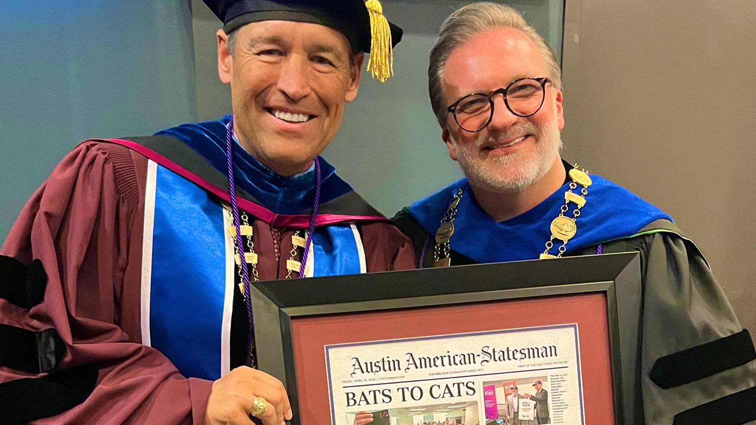 President Damphousse (left) poses for a photo with ACC Chancelor Russell Lowery-Hart holding a newspaper clipping of the Bats to Cats transfer partnership.