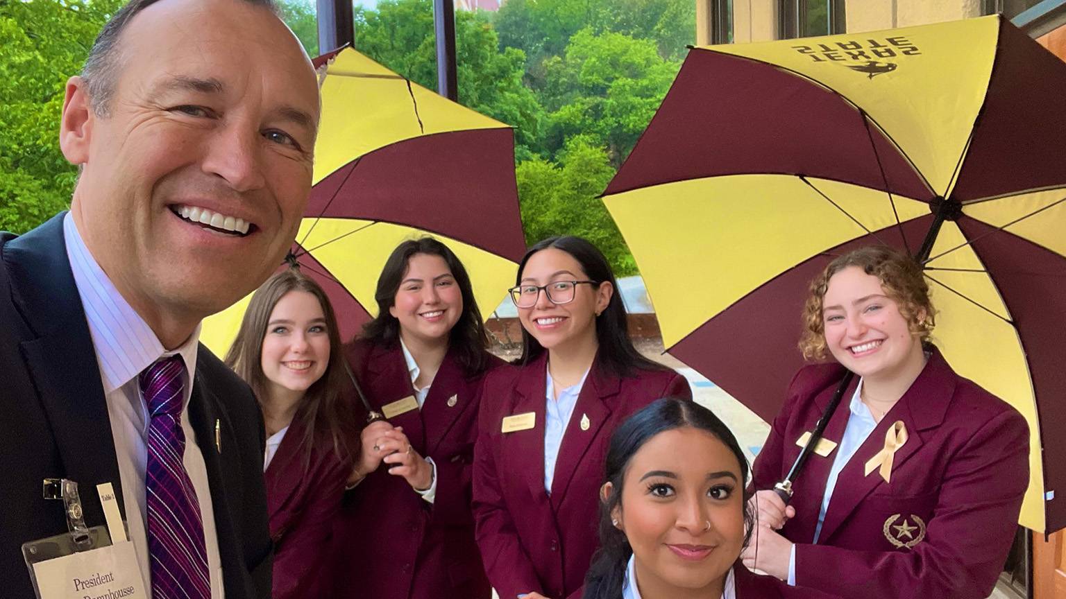 President Damphousse (left) poses for a photo with the Gold Star Society students.