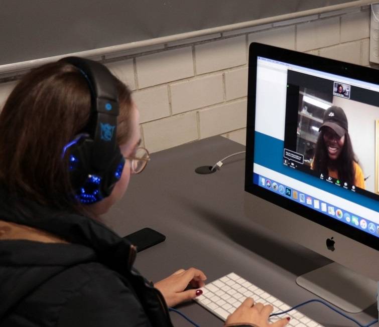 Student interacting with another who is online.