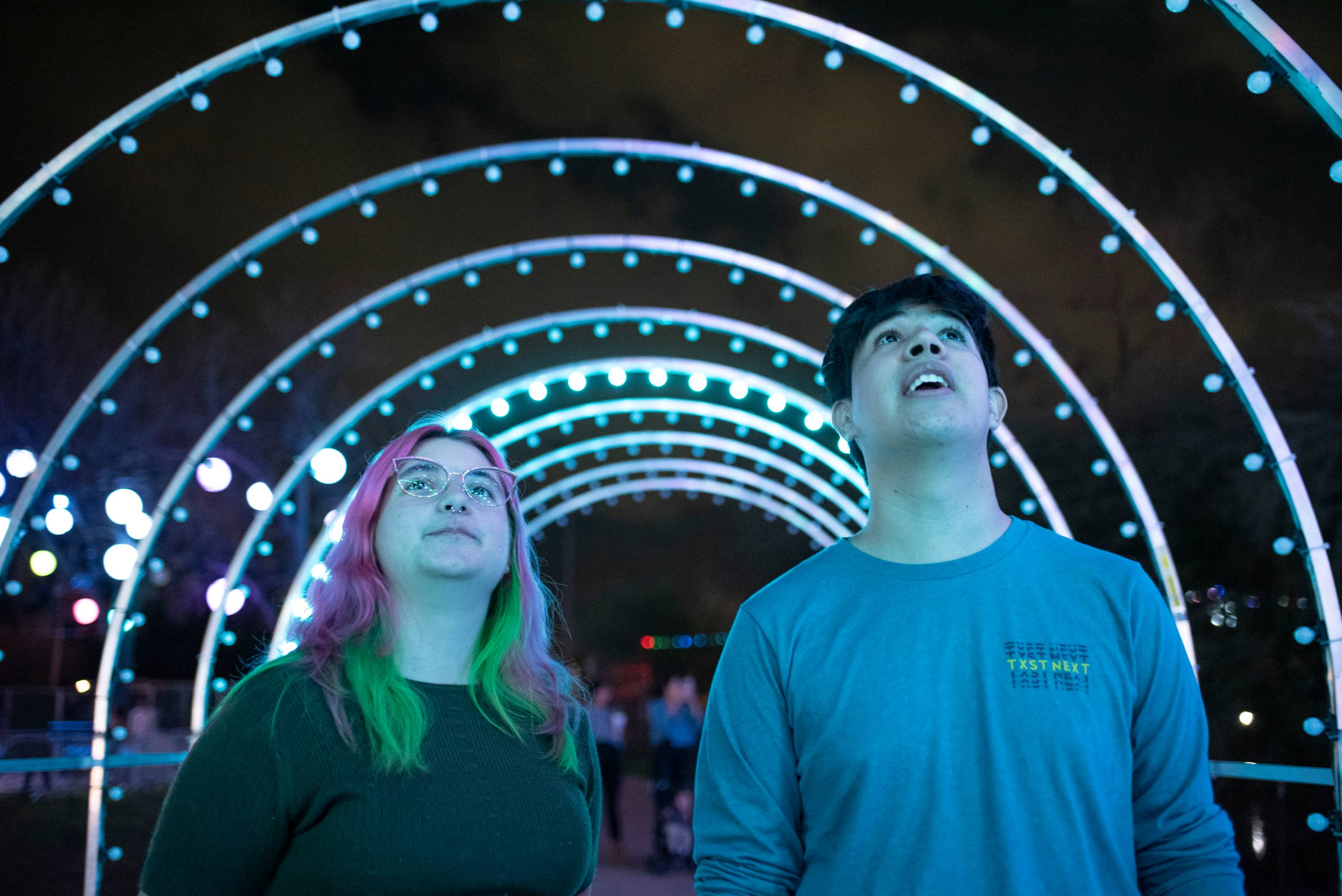 Texas state students look at multi-colored lights in awe