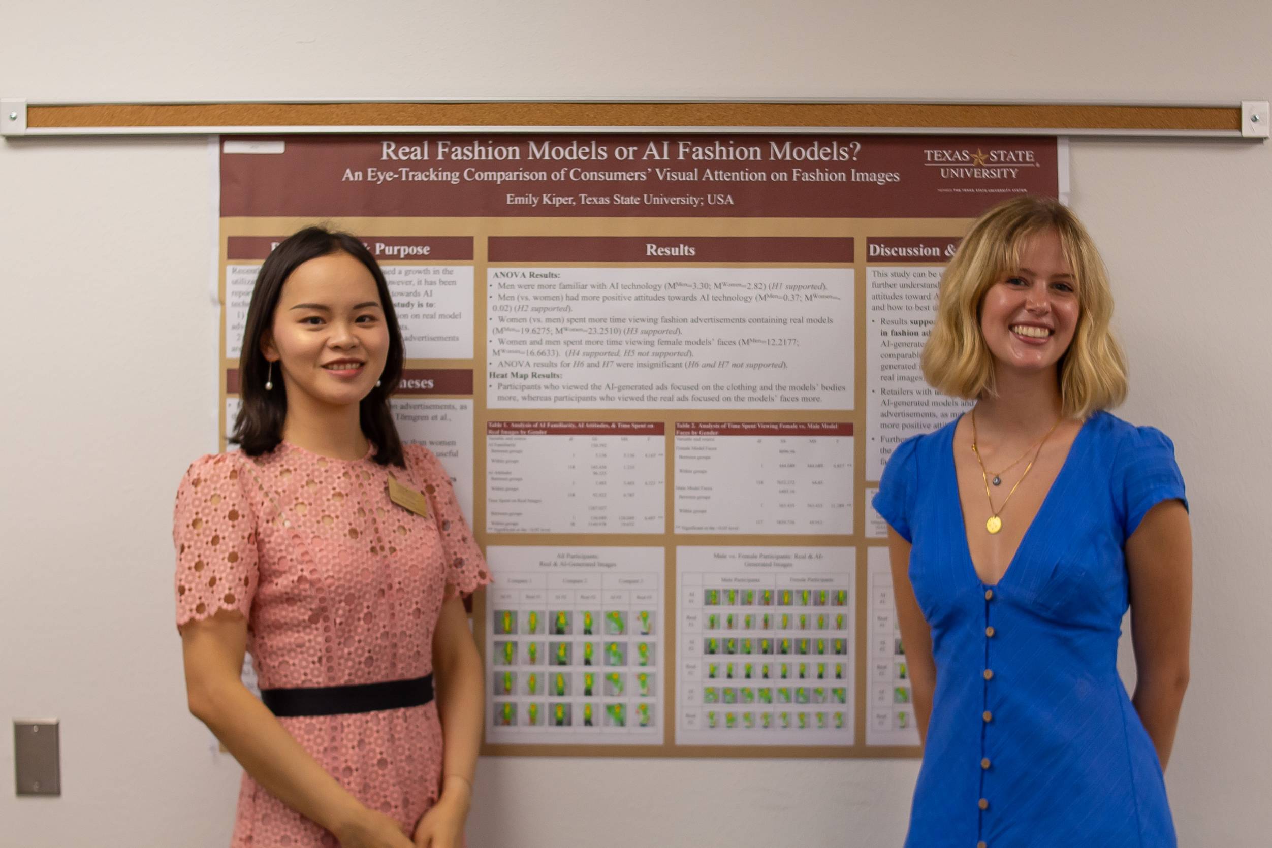 a student and faculty member standing next to research posters