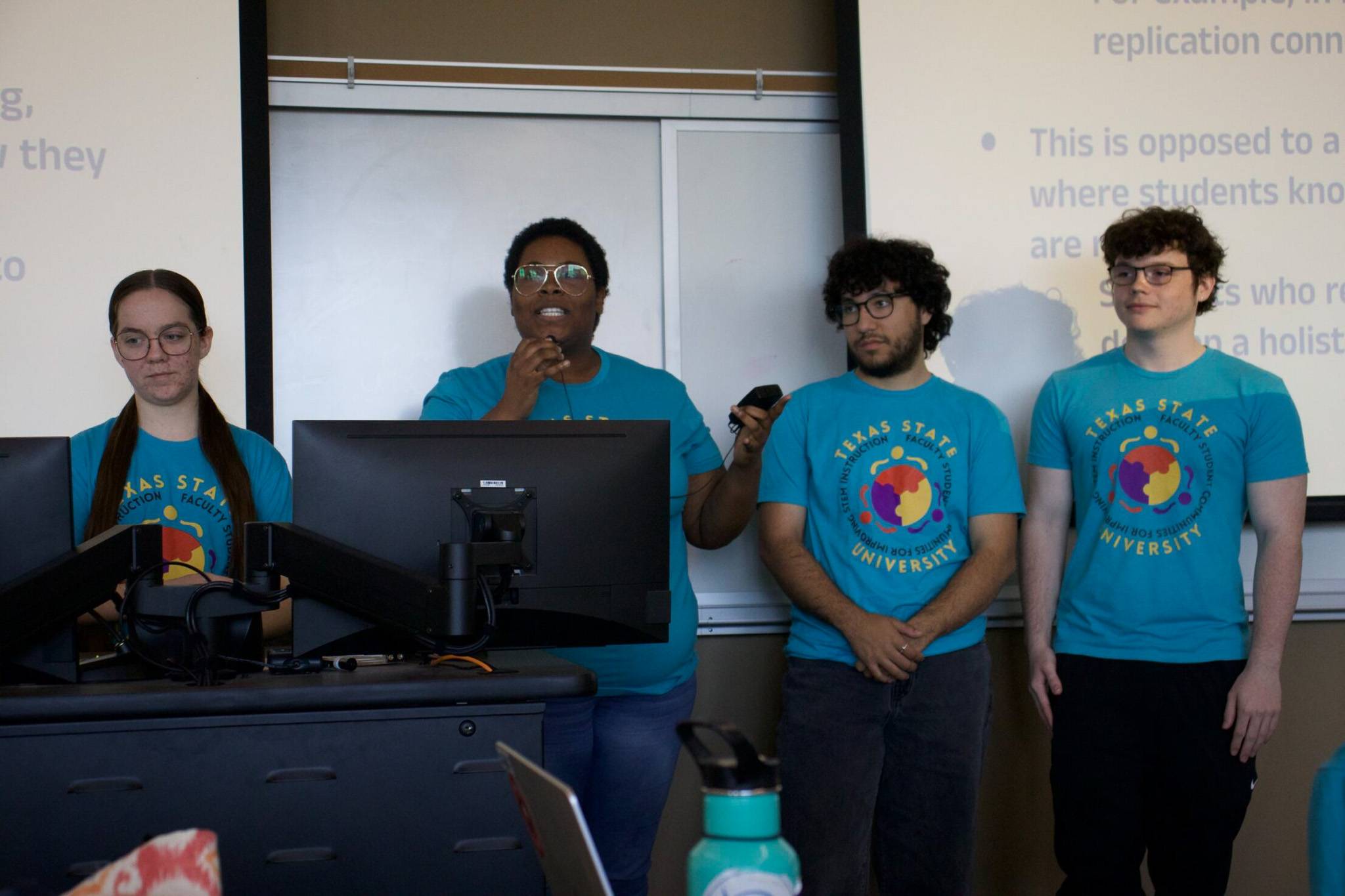 Four students presenting during community session
