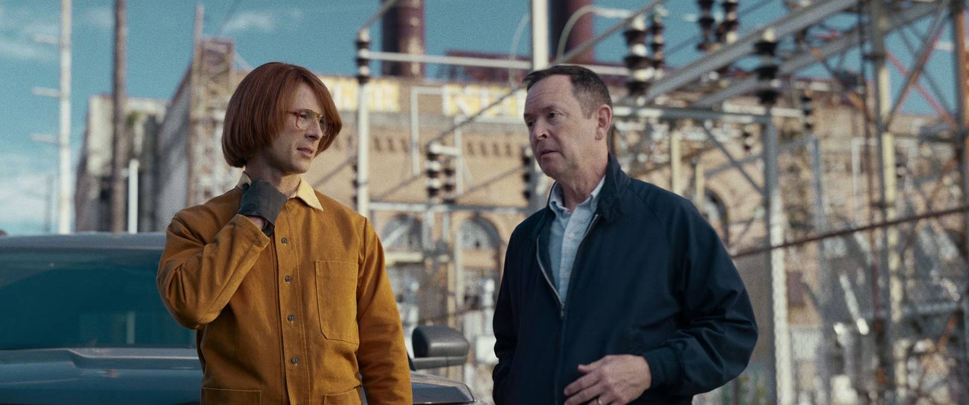 Glen Powell (left) and Richard Robichaux in a scene in the film 'Hit Man.'