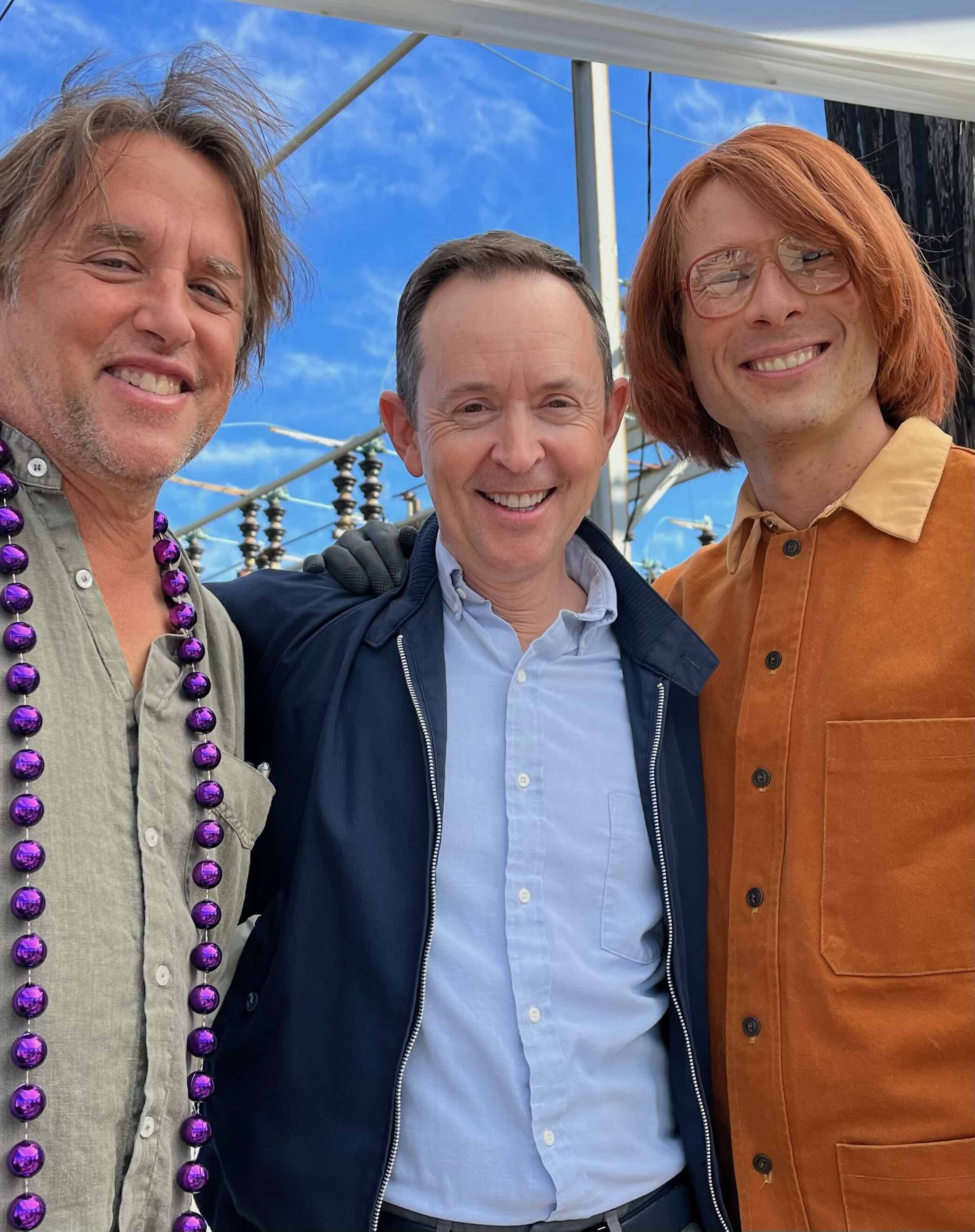 Richard Linklater (left), Robichaux, and Powell pose for a photo behind the scenes of the film 'Hit Man.'