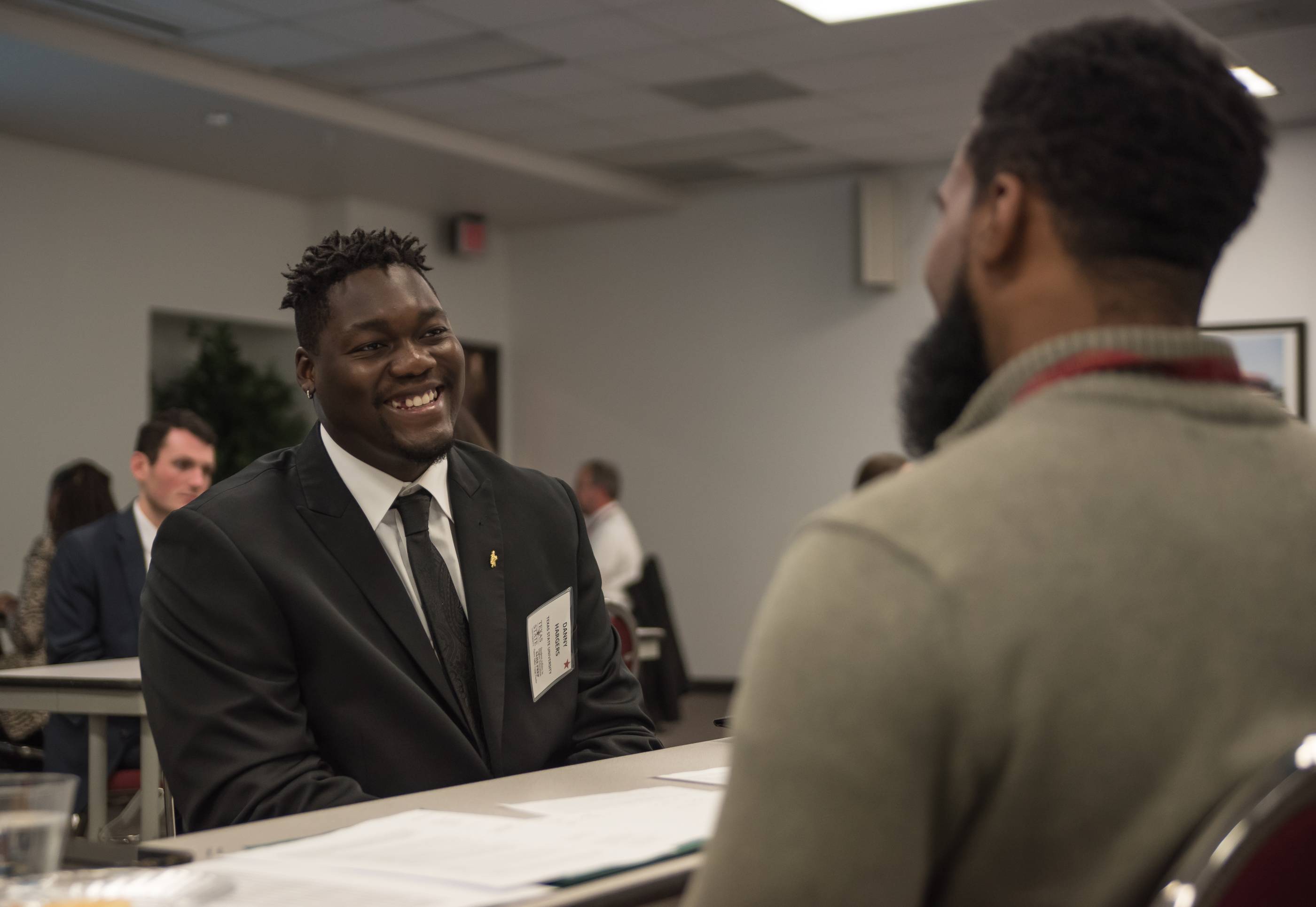 A sharply dressed student having a conversation.