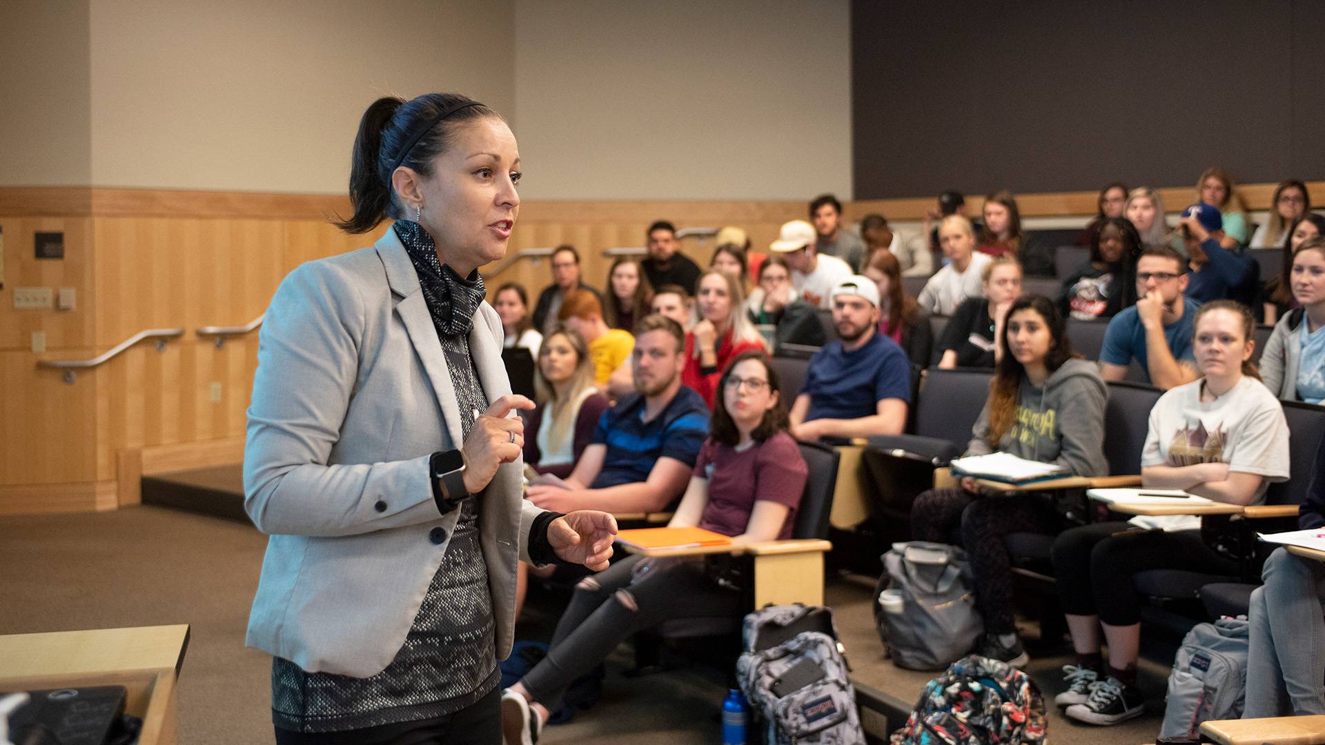 Professor talking at the front of a classroom