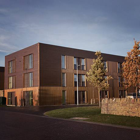 Exterior of three story UHI Inverness Residence Hall and surrounding landscape.
