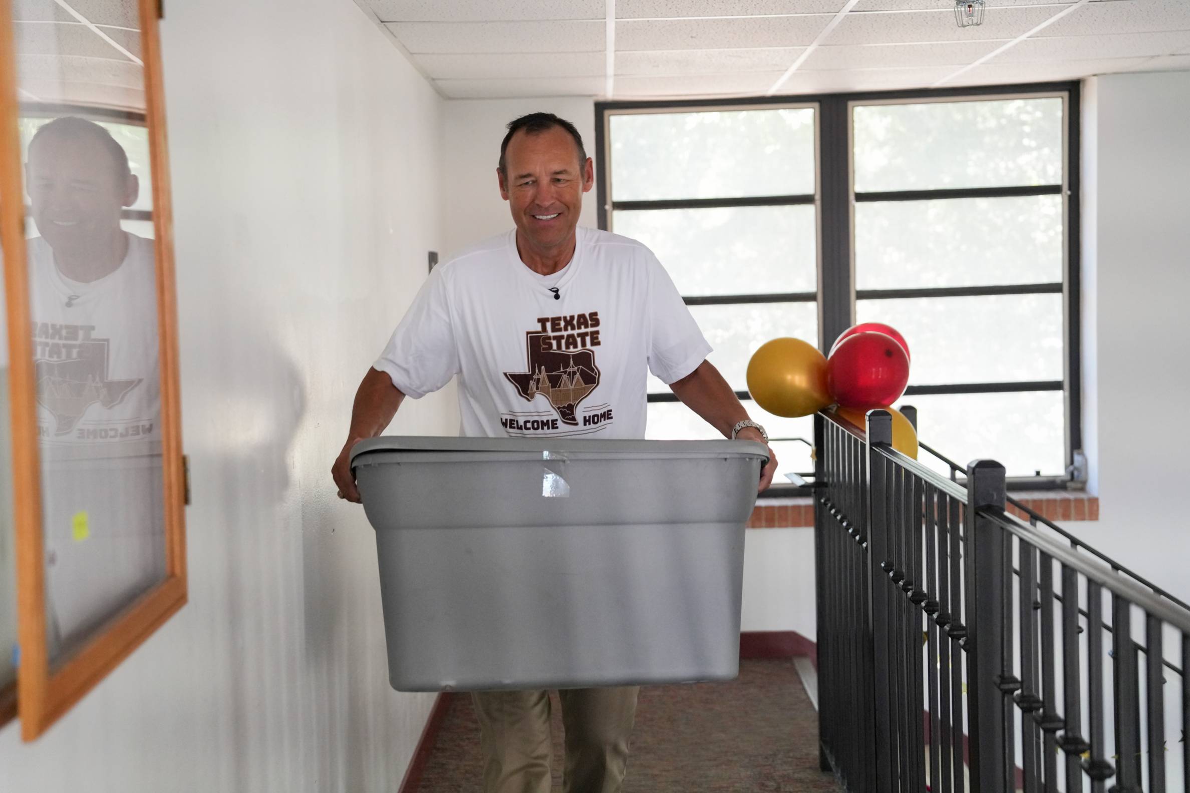 man moving plastic tote bin