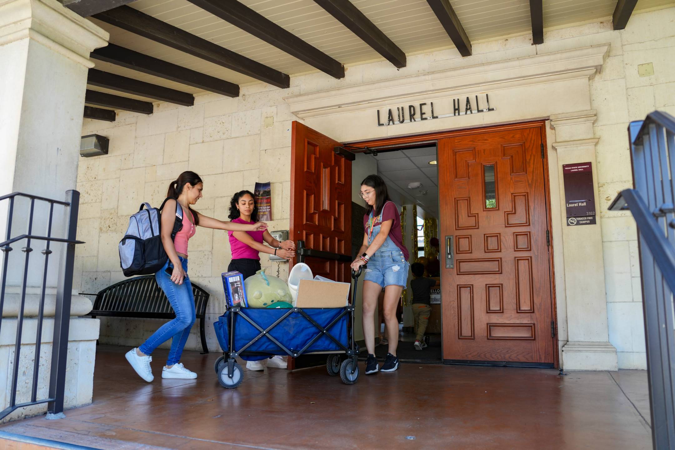 people pulling wagon into a building 