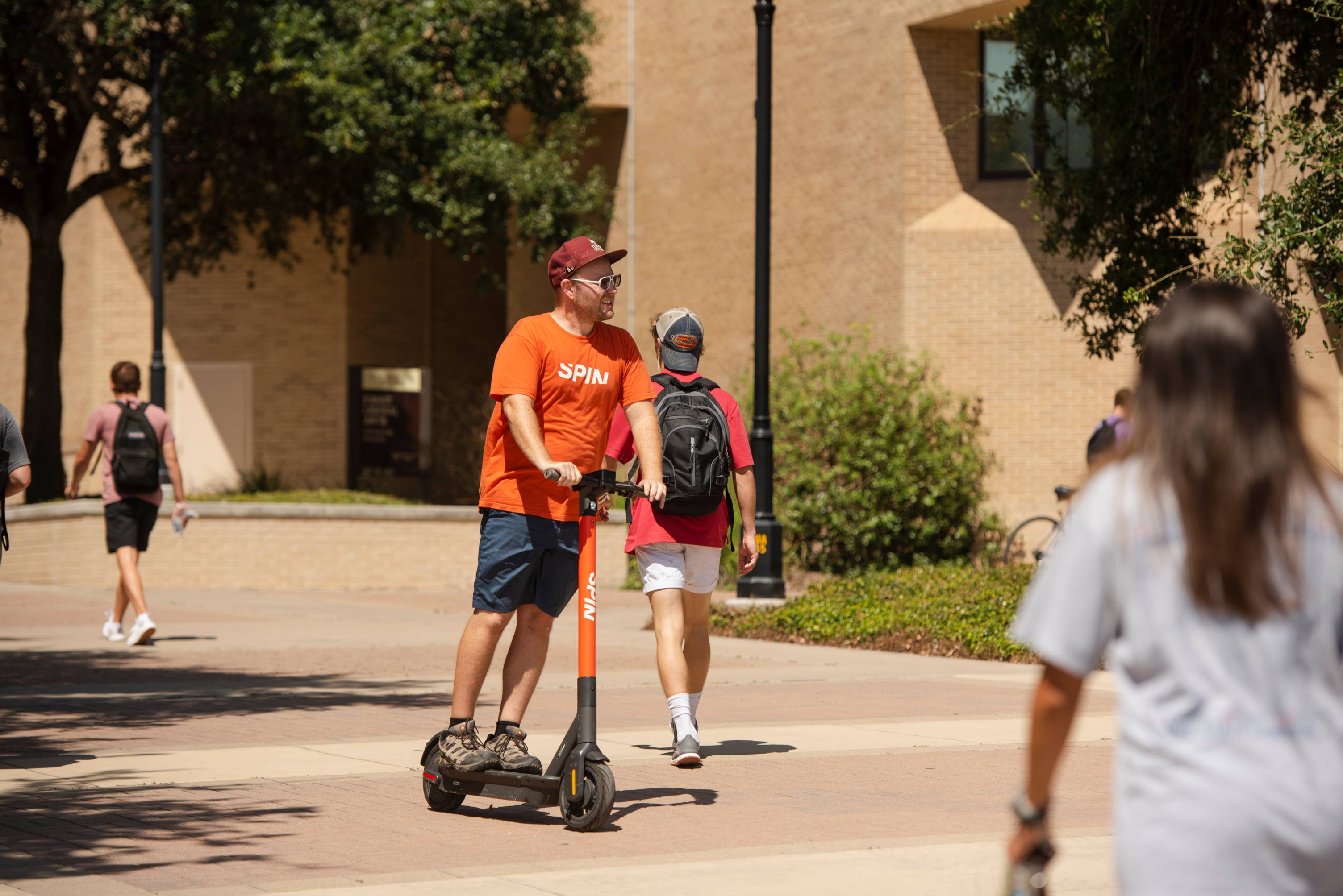 man standing on scooter