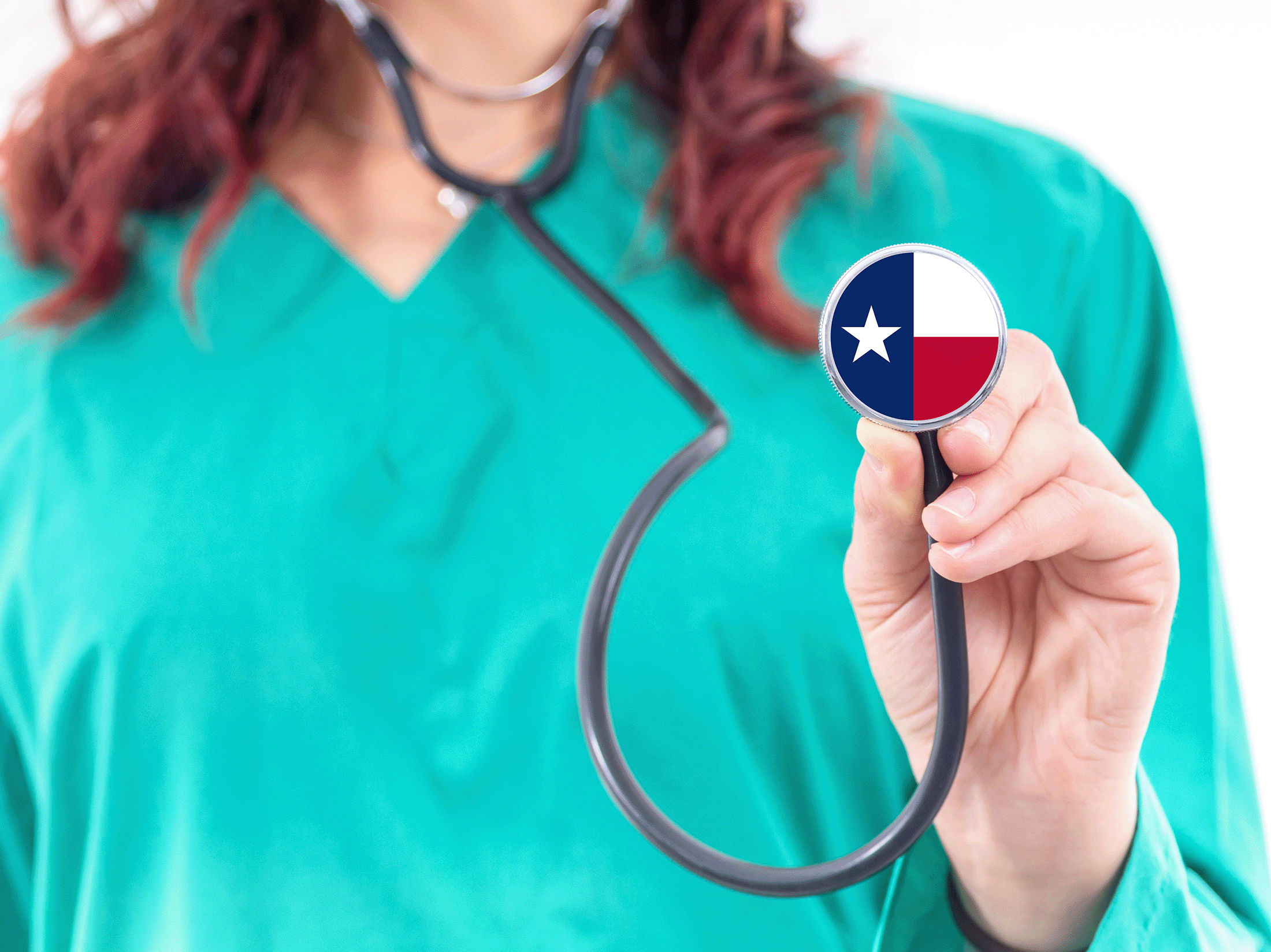 A nurse holding up a stethoscope with Texas flag image on it
