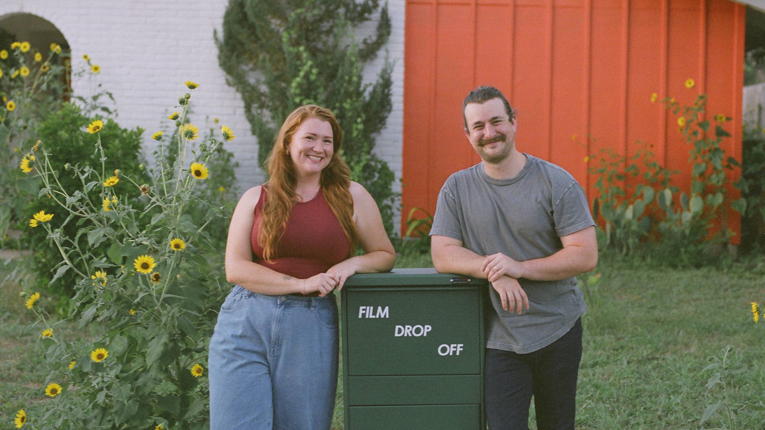 Texas State University alum Holly McVeety-Mill (left) and husband AJ Gerstenhaber stand next to their film drop box outside their home in Austin.