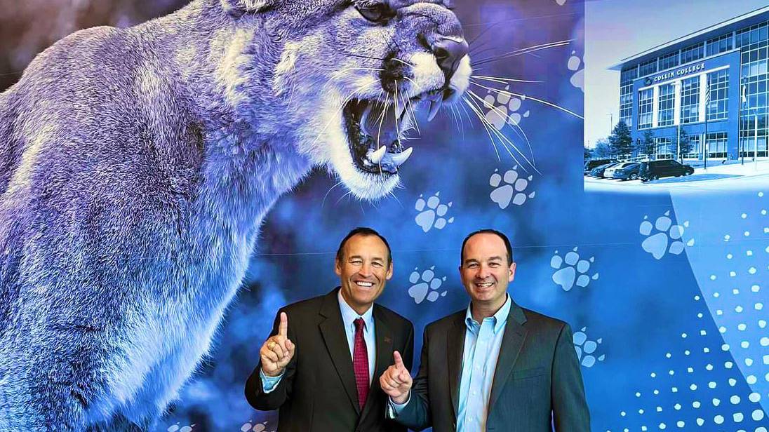 President Damphousse (left) poses for a photo with Jay Corwin in front of a cougars image.