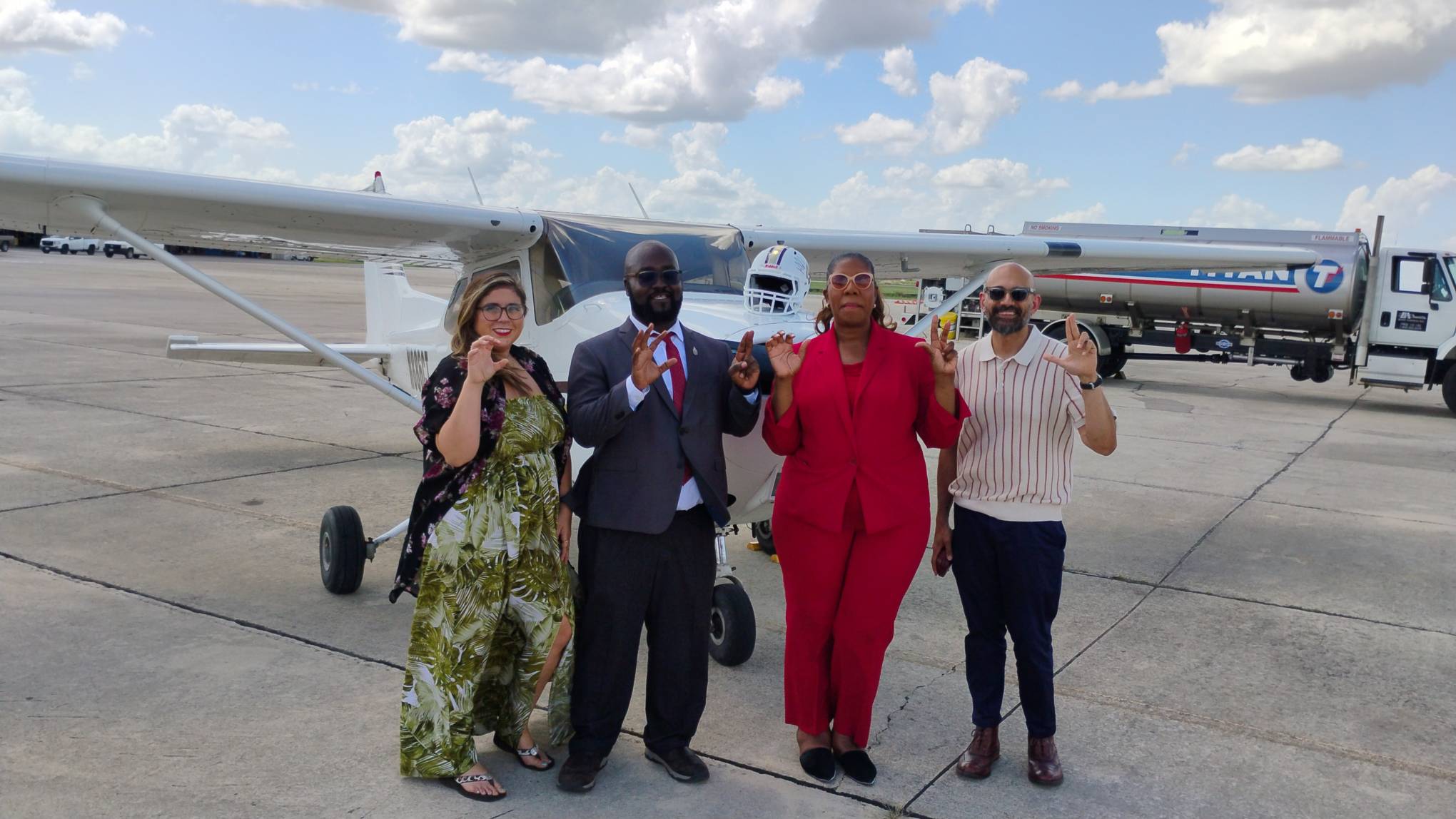 4 owls faculty and staff in front of txst plane