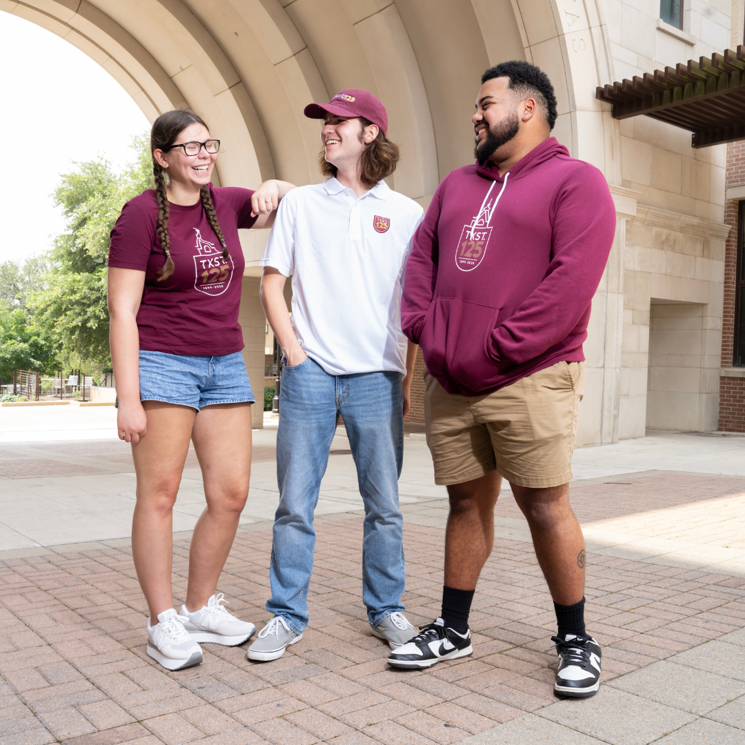 TXST students wearing merchandise from the TXST 125 line. Image links to online store