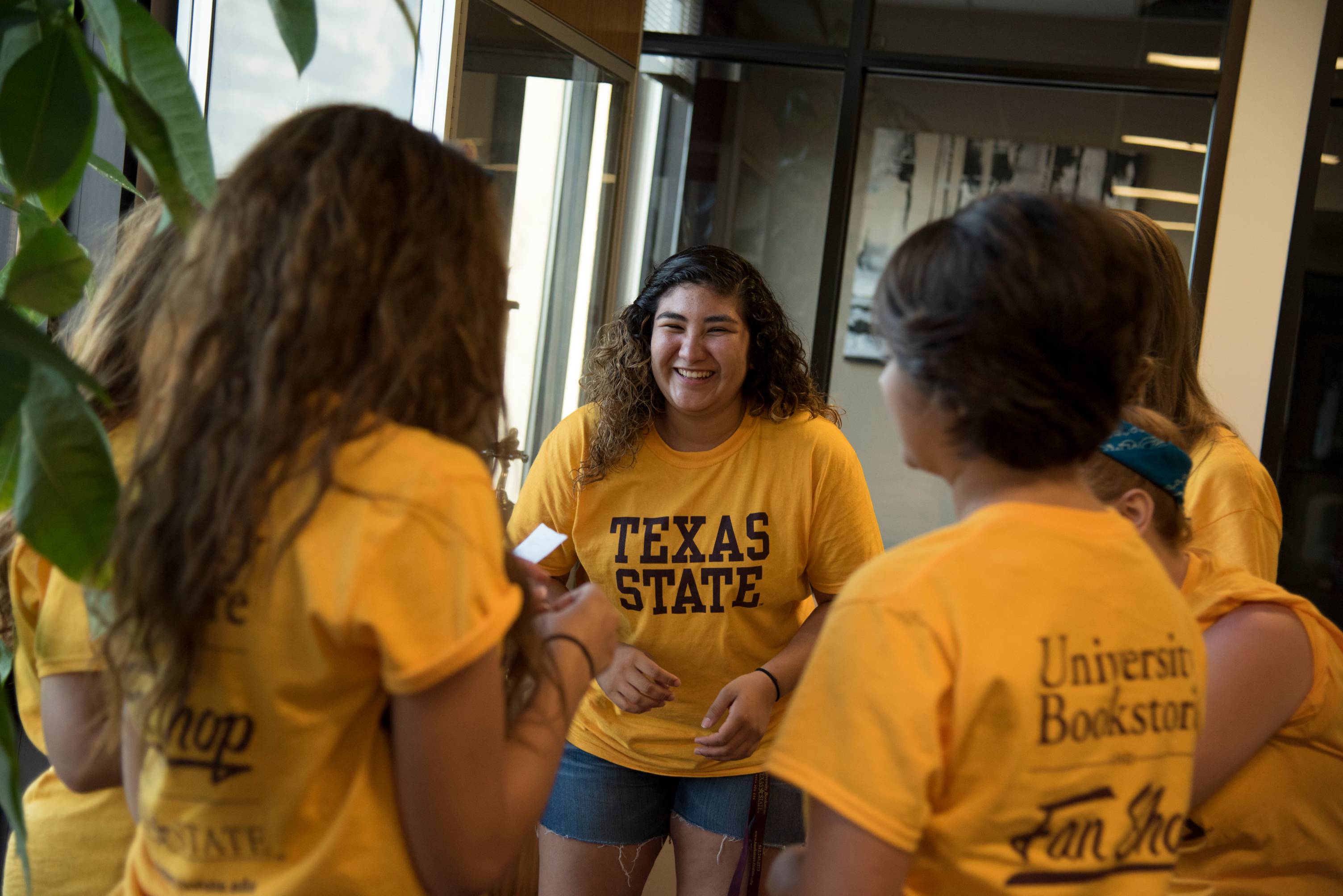 Students standing and smiling