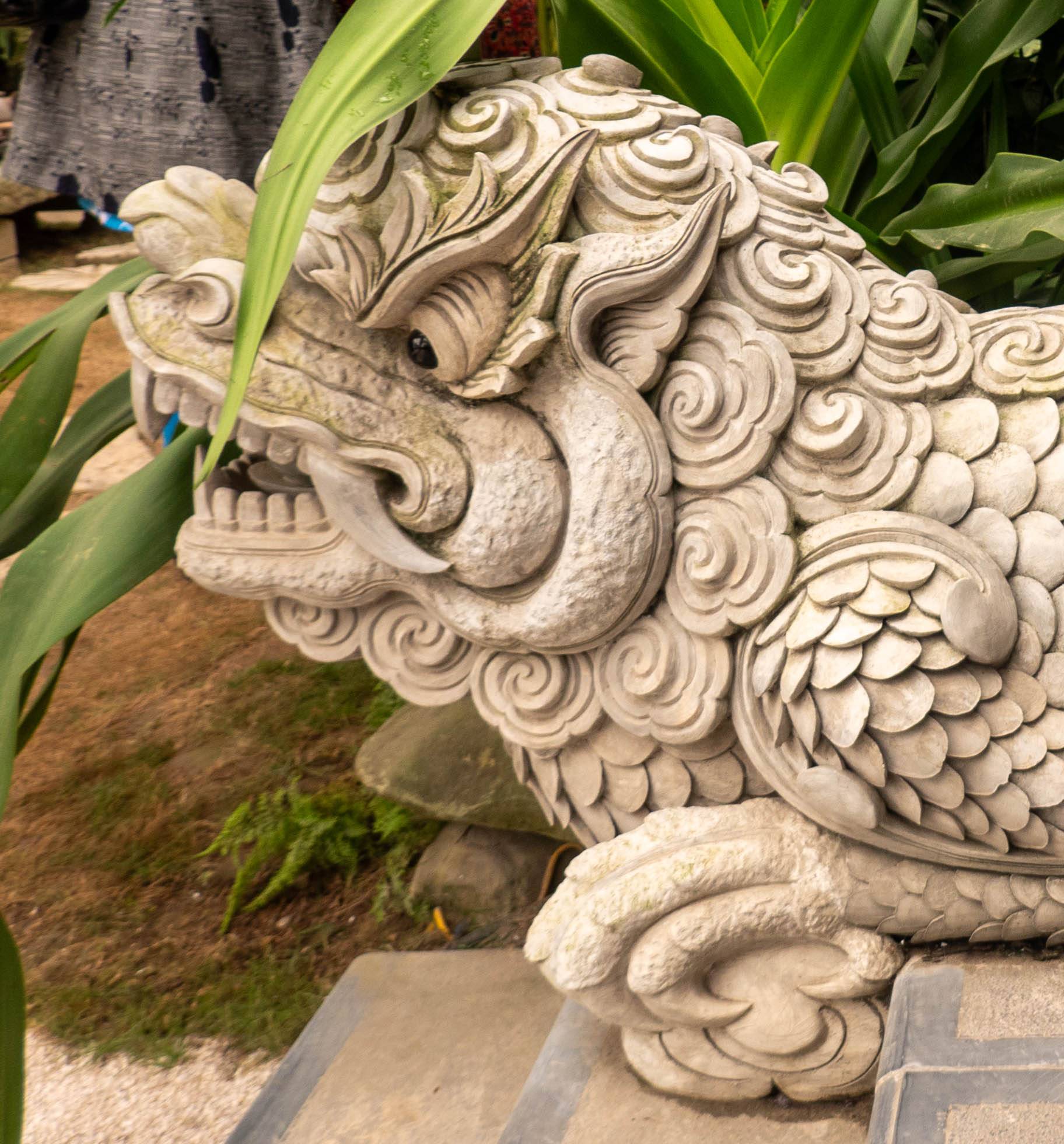 Profile view of a head of Vietnamese unicorn statue looking to left.