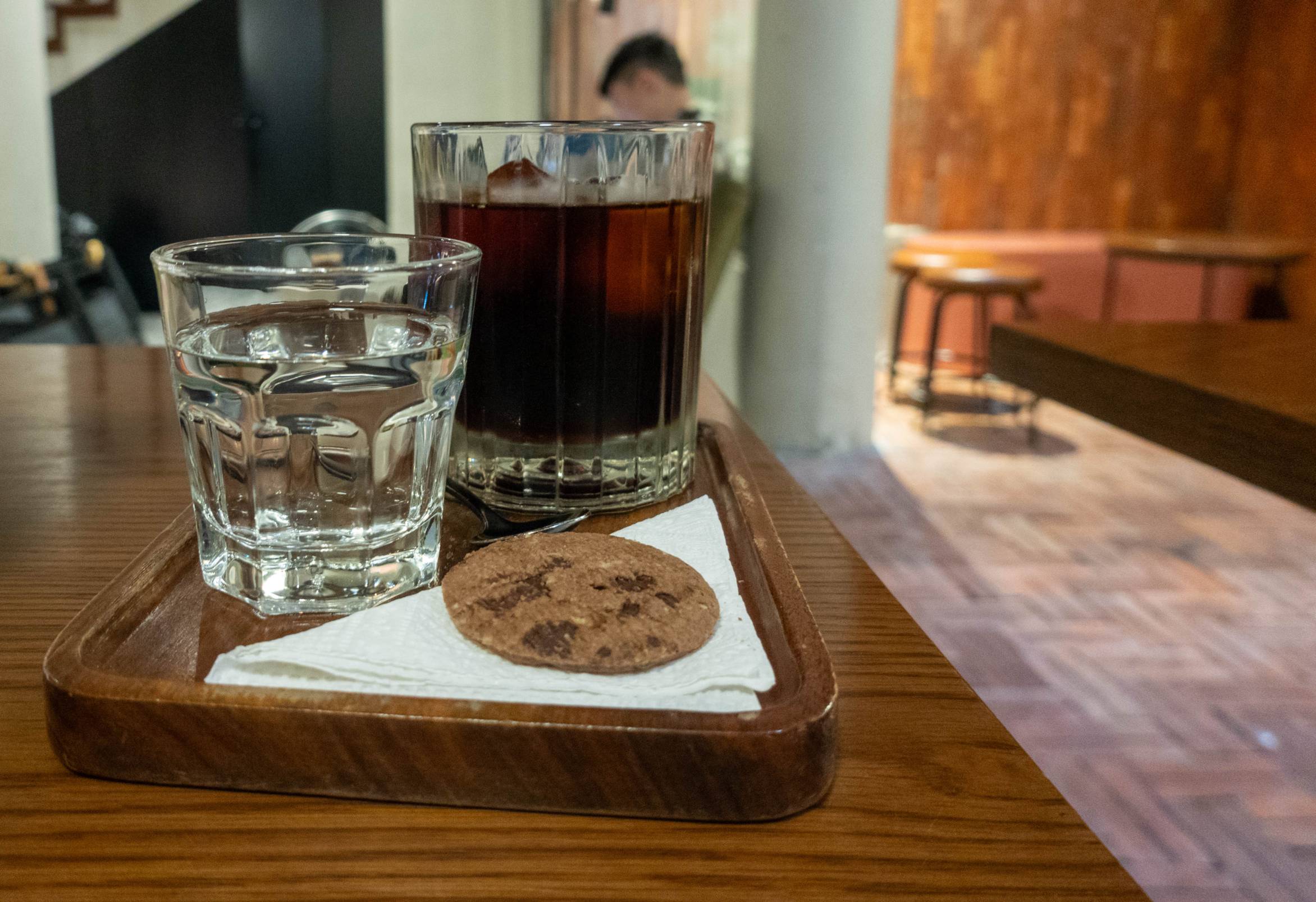 Coffee, water, and a choclate chip cookie