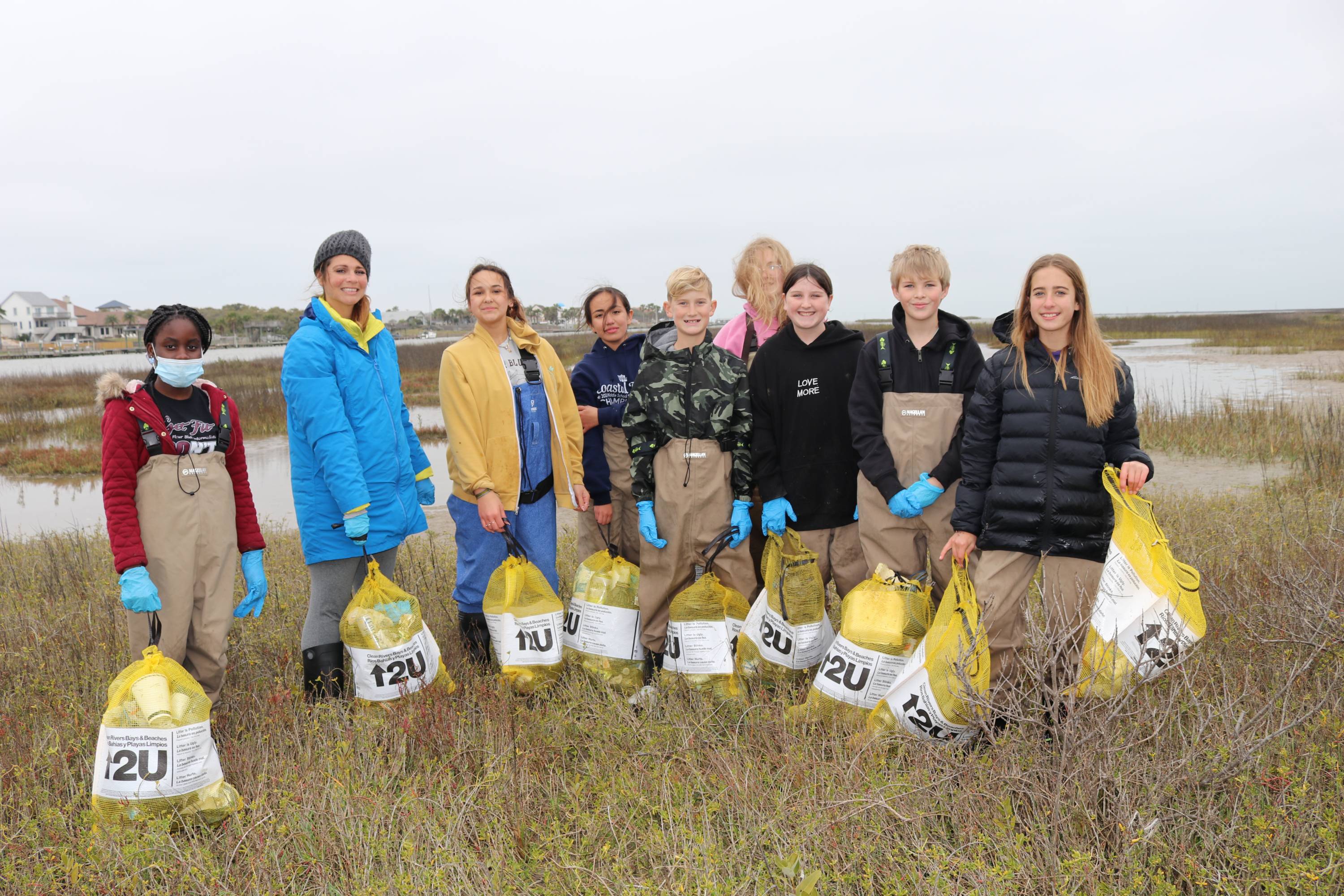 Katie Doyle and her students collecting trash from local environment