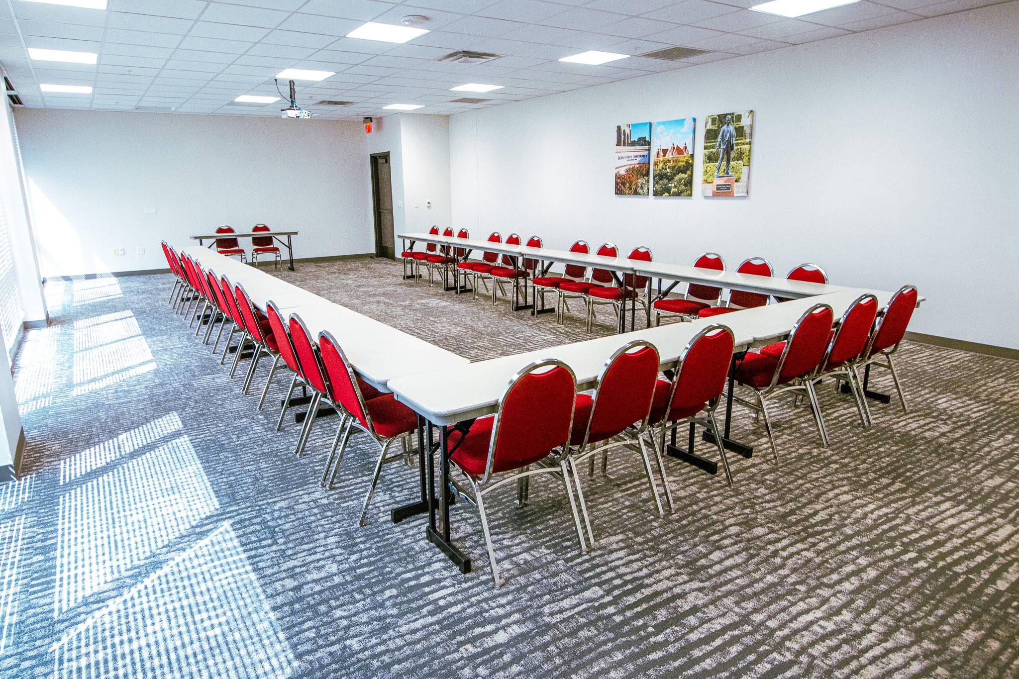 A room with circular tables and chairs