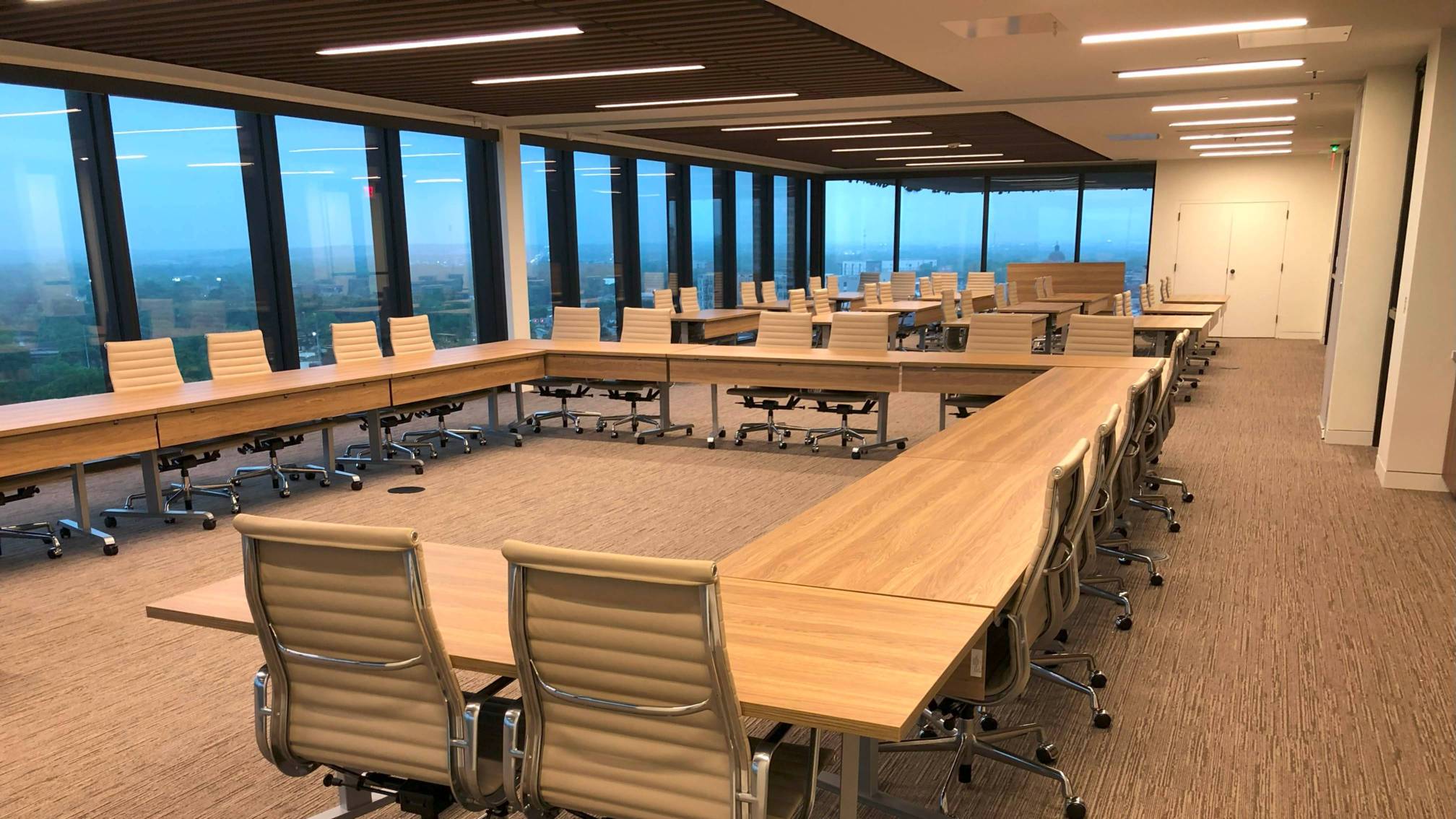 A meeting room with tables and chairs