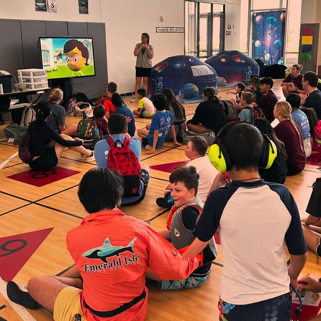 children watching video in gym