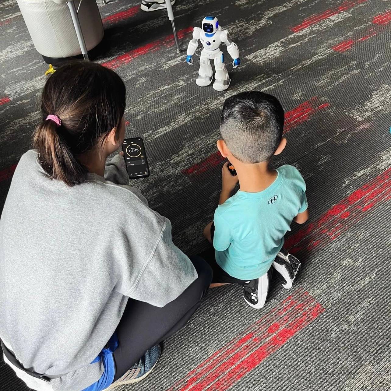 camp counselor and camper working with robots