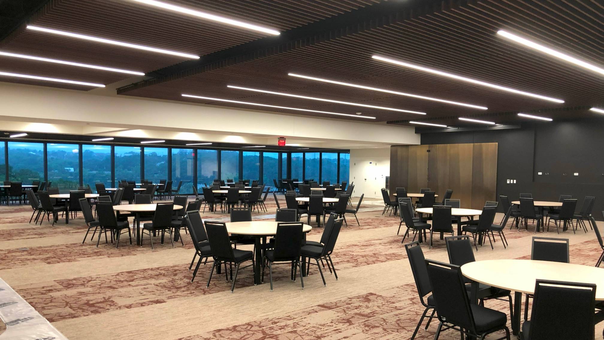 A photo of a meeting room with tables and chairs