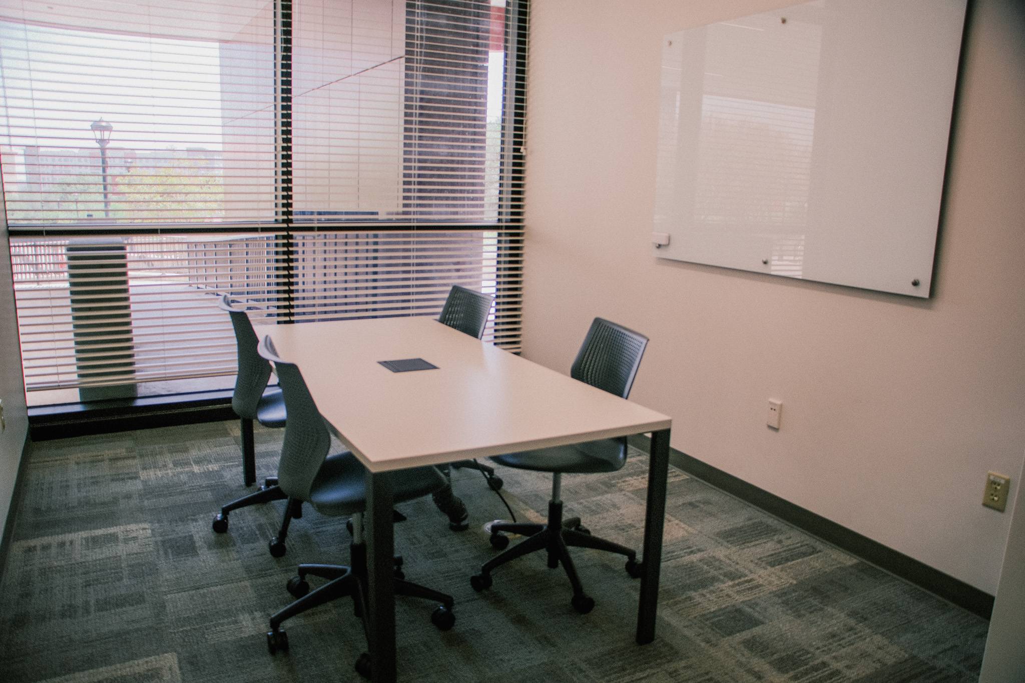 A small meeting room with tables and chairs