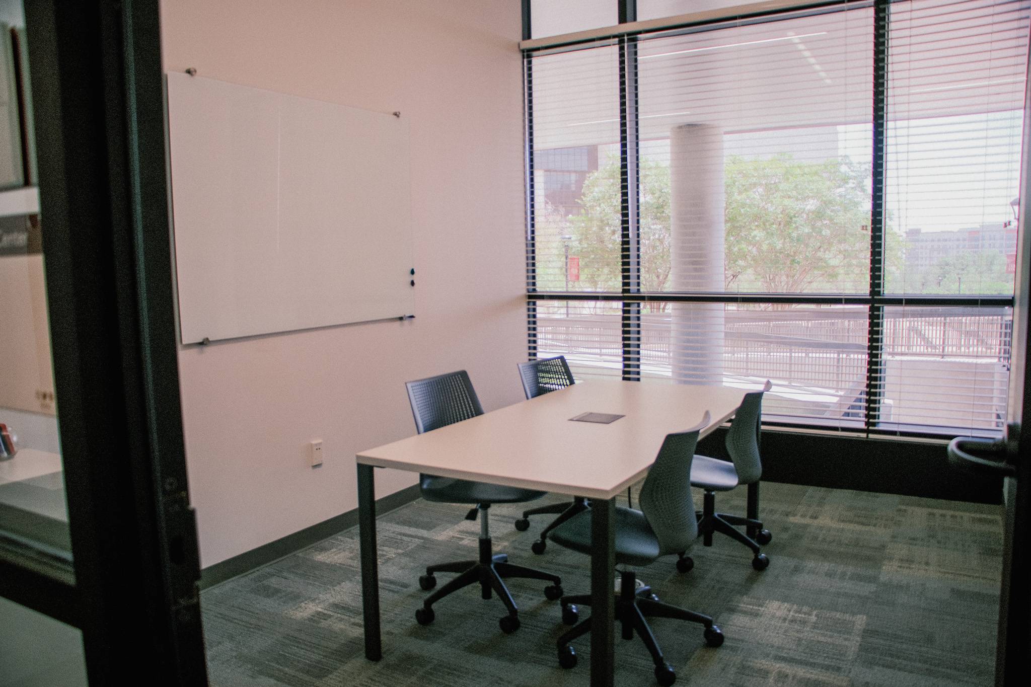 A small meeting room with tables and chairs