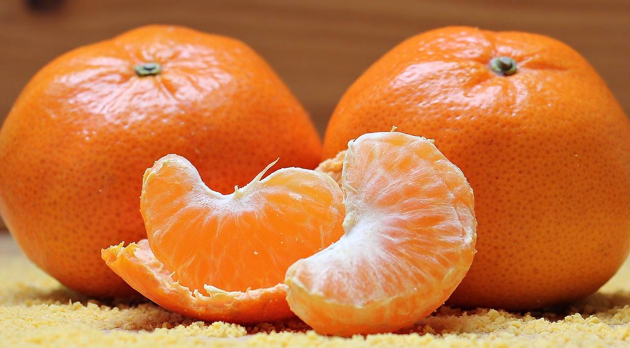 A tangerine peeled lays on a table.