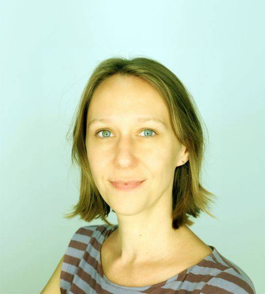 woman wearing striped shirt in front of light background