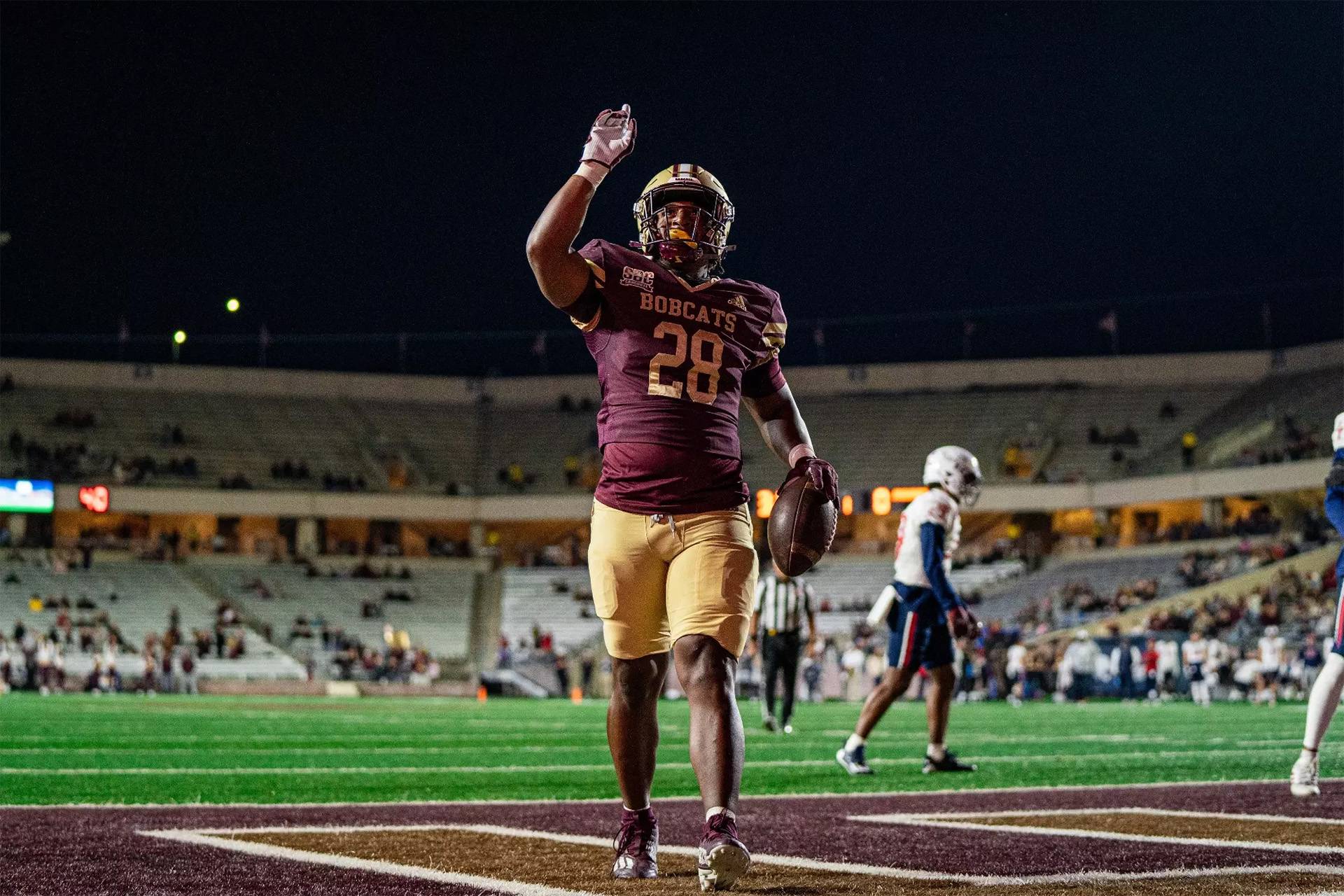 Football player with hand in the air during game