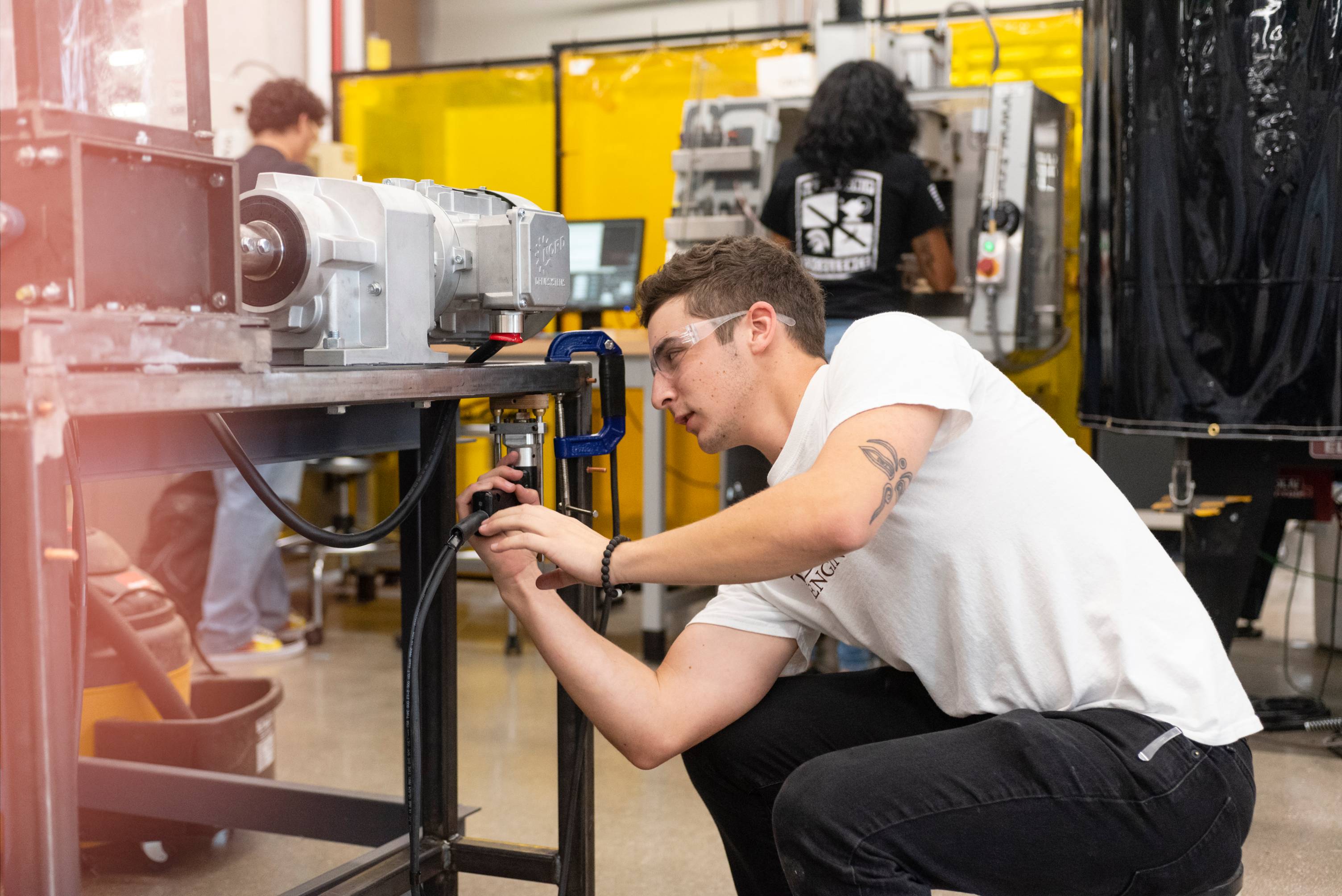 an engineering student assembling a machine