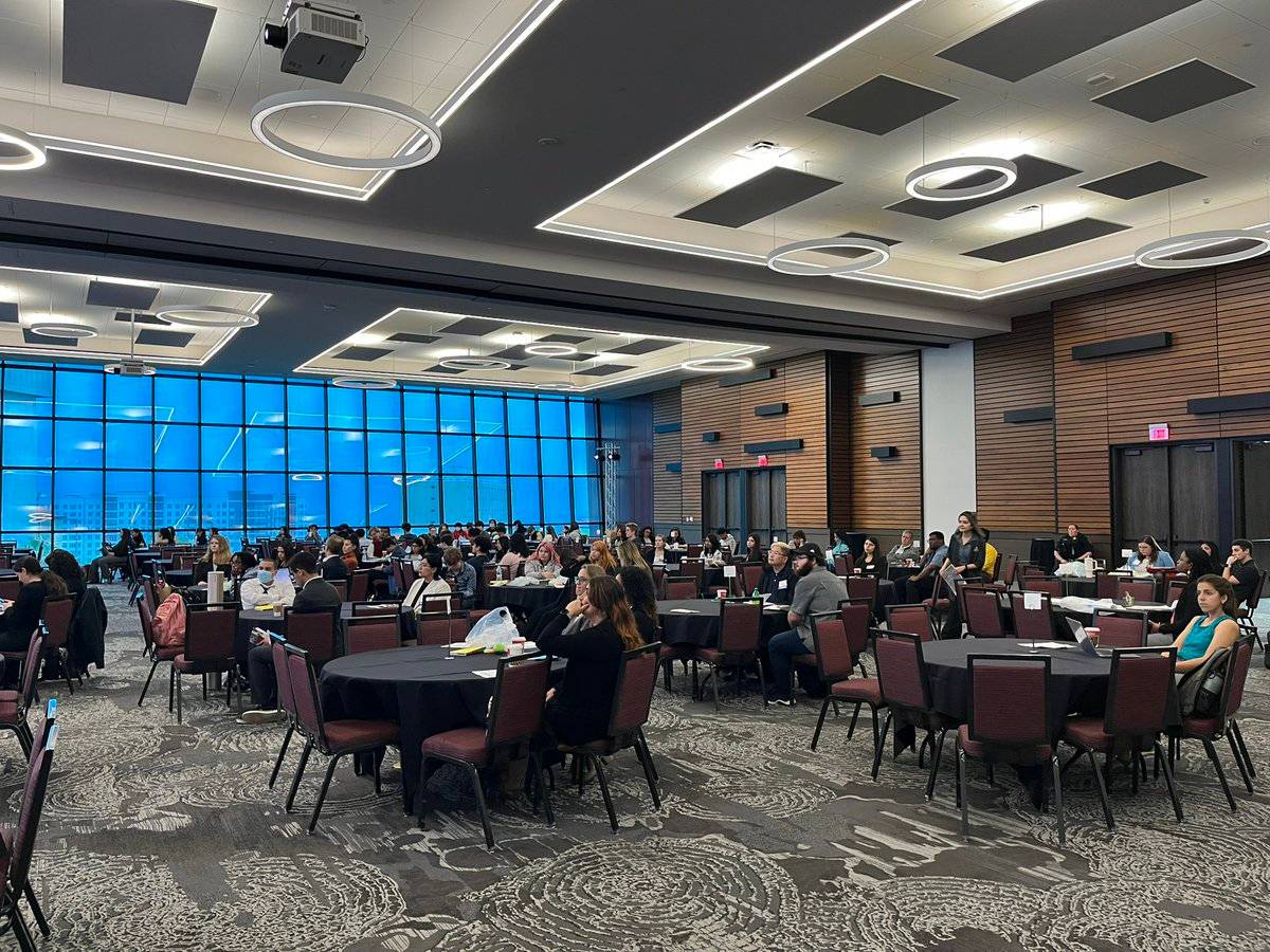 Attendees sitting at tables at the TXST STEM conference panel.