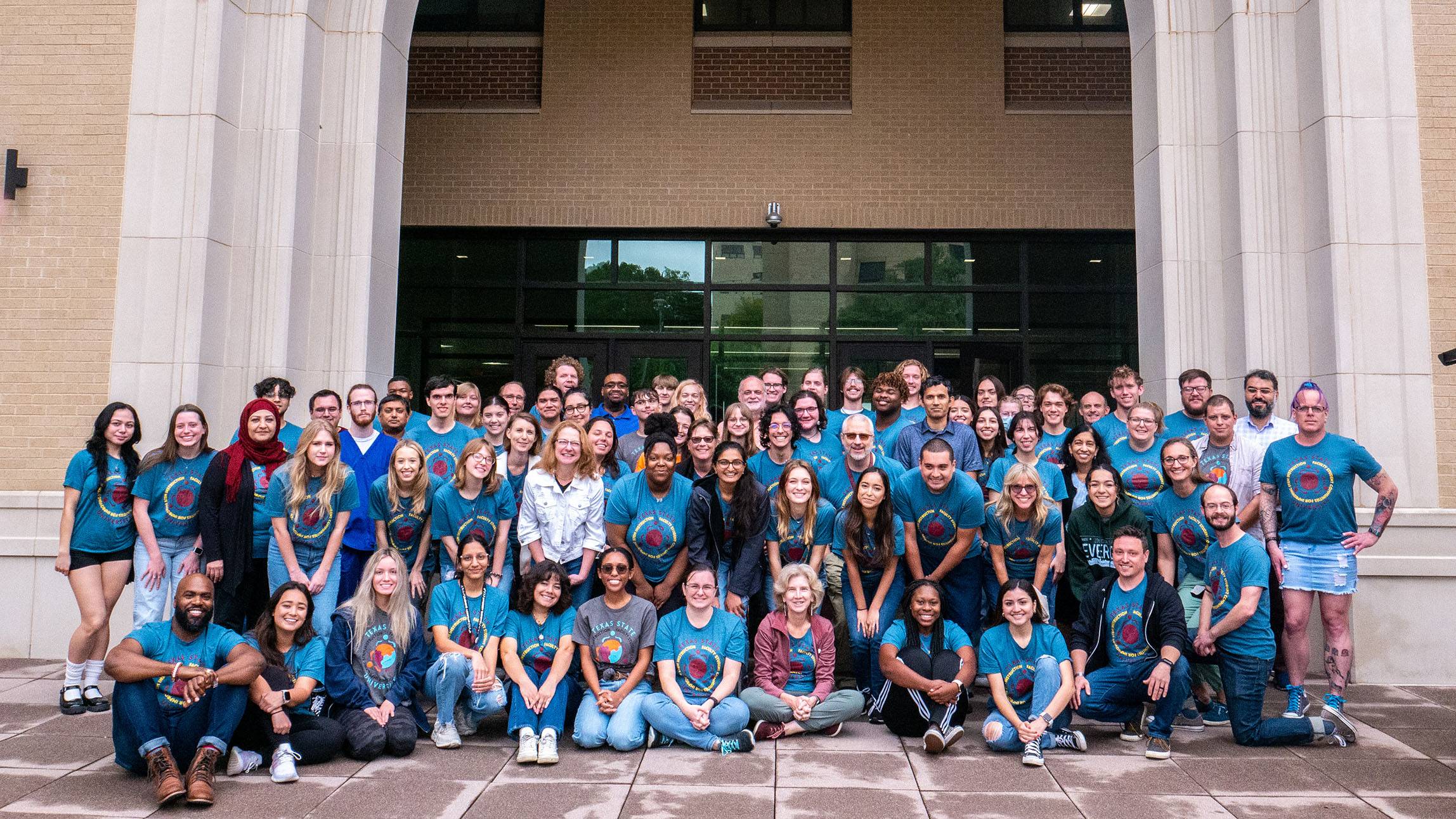 A large group of students and faculty pose for a photo.