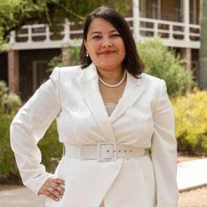 woman wearing white blazer in front of building