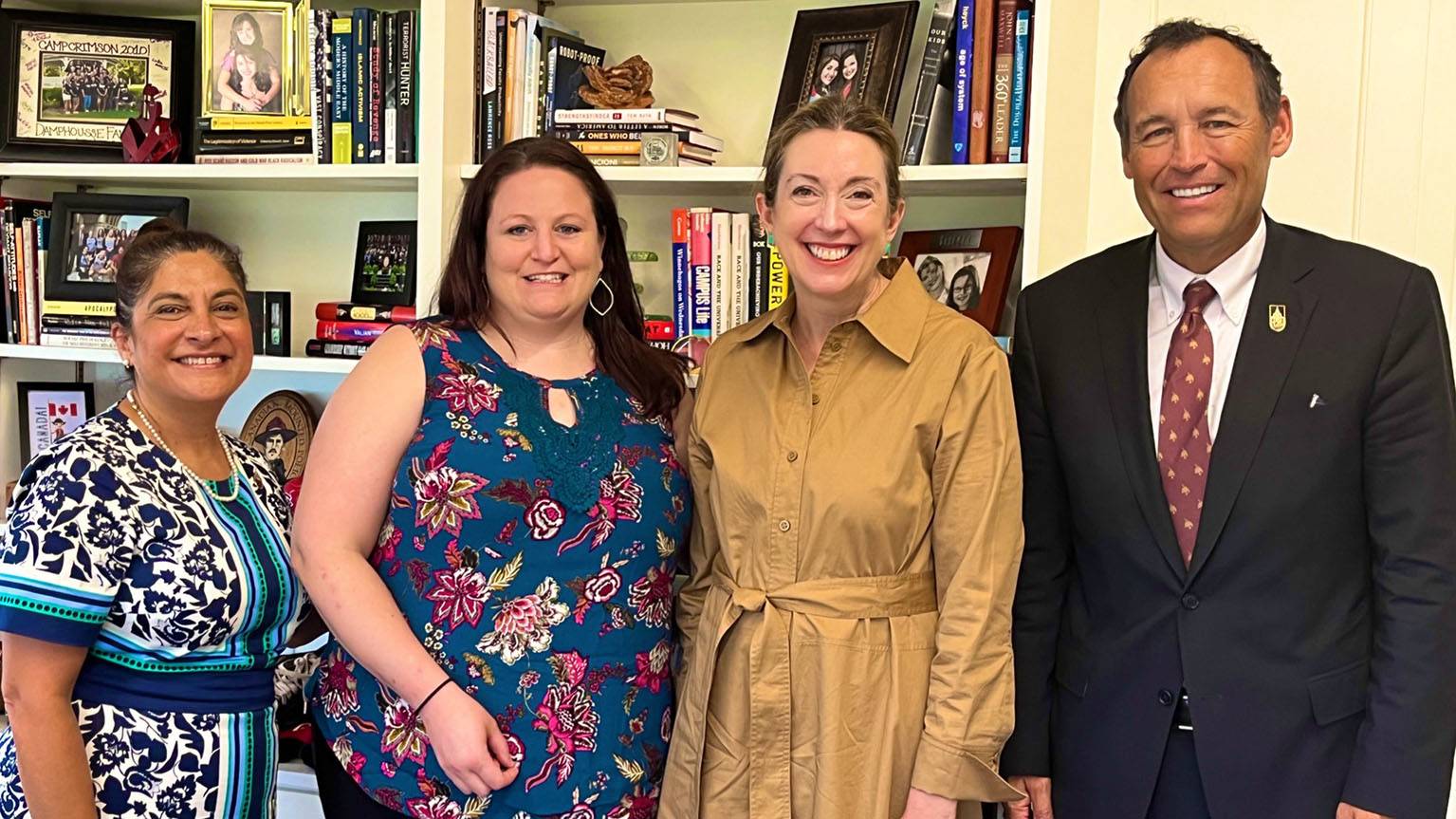 Dr. Cynthia Hernandez (left) poses for a photo with Foster Angels of Central Texas representatives and President Damphousse (right).