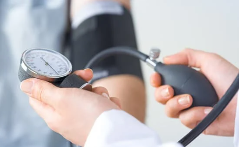 a doctor taking a persons blood pressure