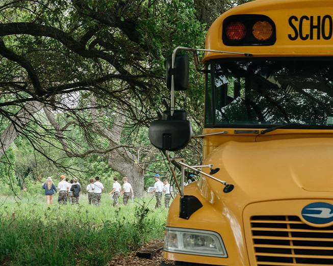 students leaving bus at Spring Lake for field trip