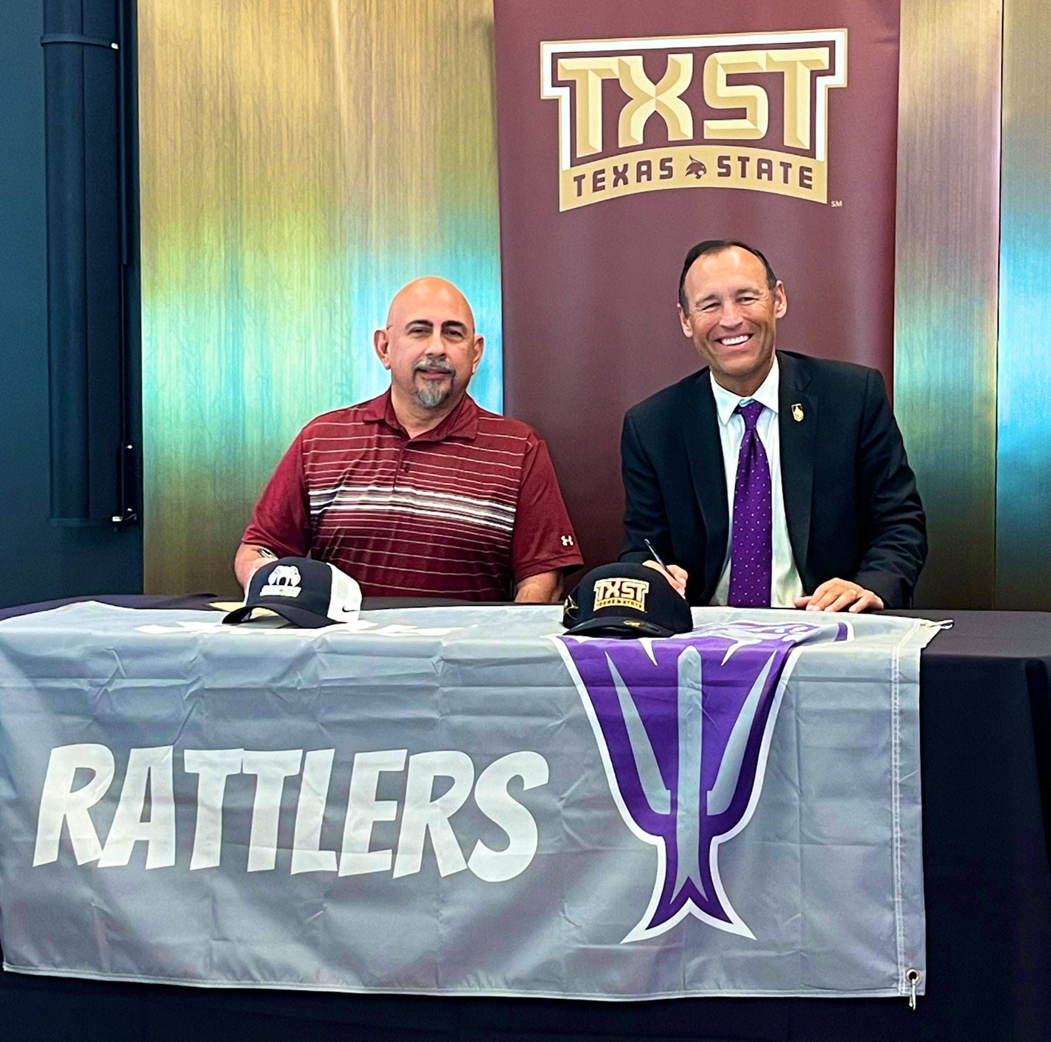 San Marcos CISD Superintendent Michael Cardona (left) and TXST President Kelly Damphousse pose for a photo together at the signing ceremony.