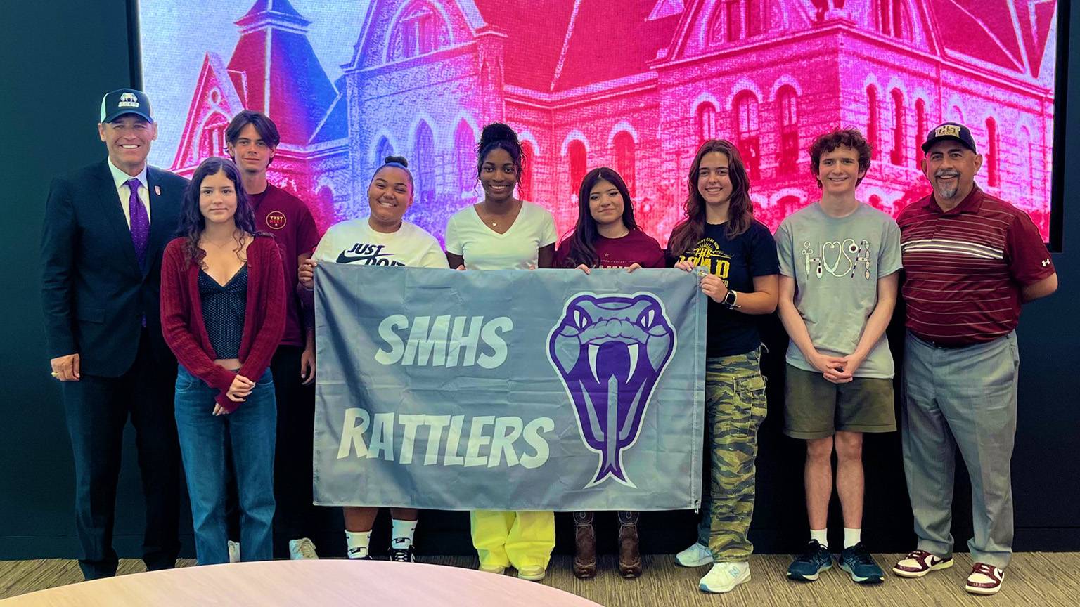 TXST President Kelly Damphousse (left) poses for a photo with San Marcos CISD high school students participating in the dual credit program with San Marcos CISD Superintendent Michael Cardona.