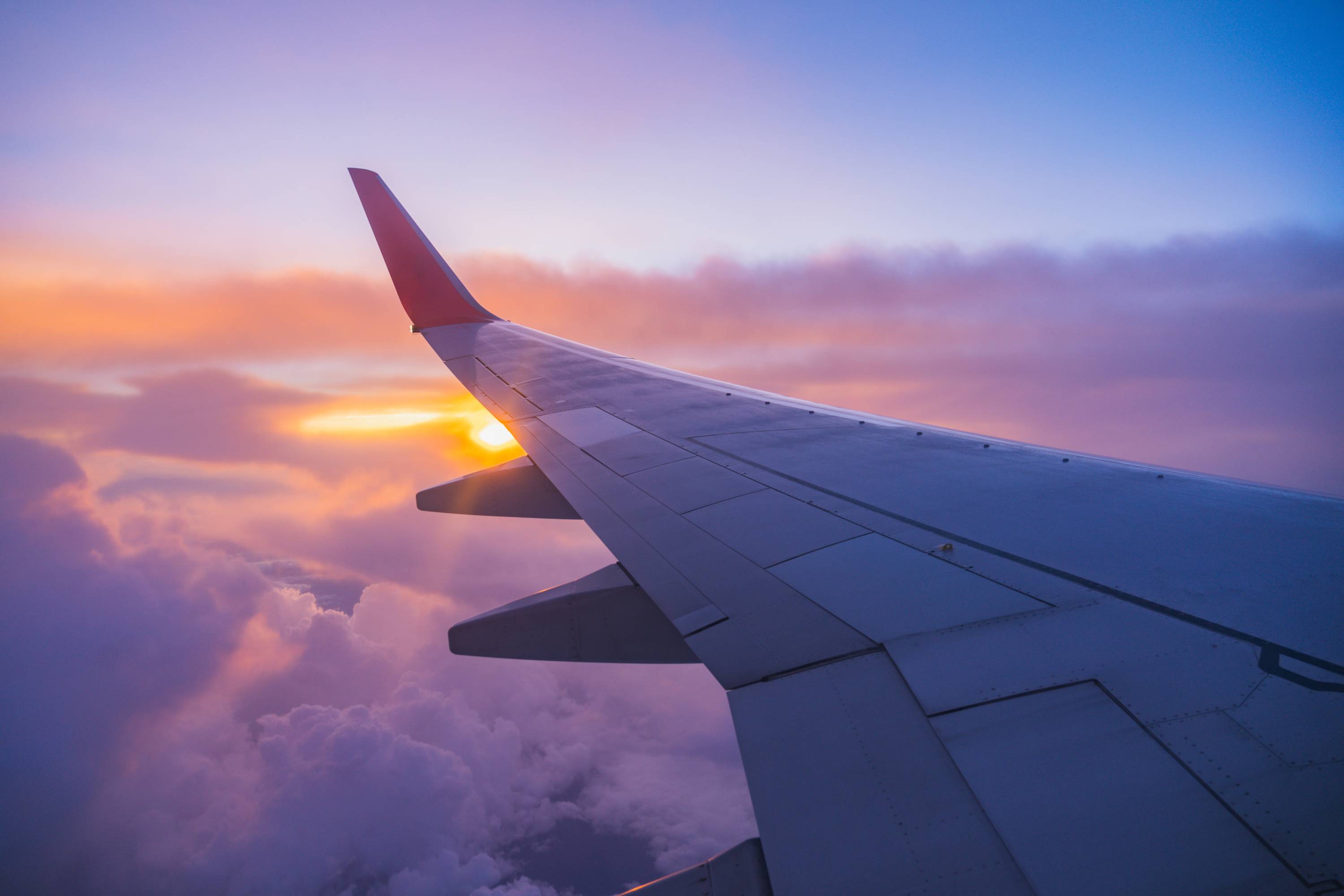 Airplane wing at sunset