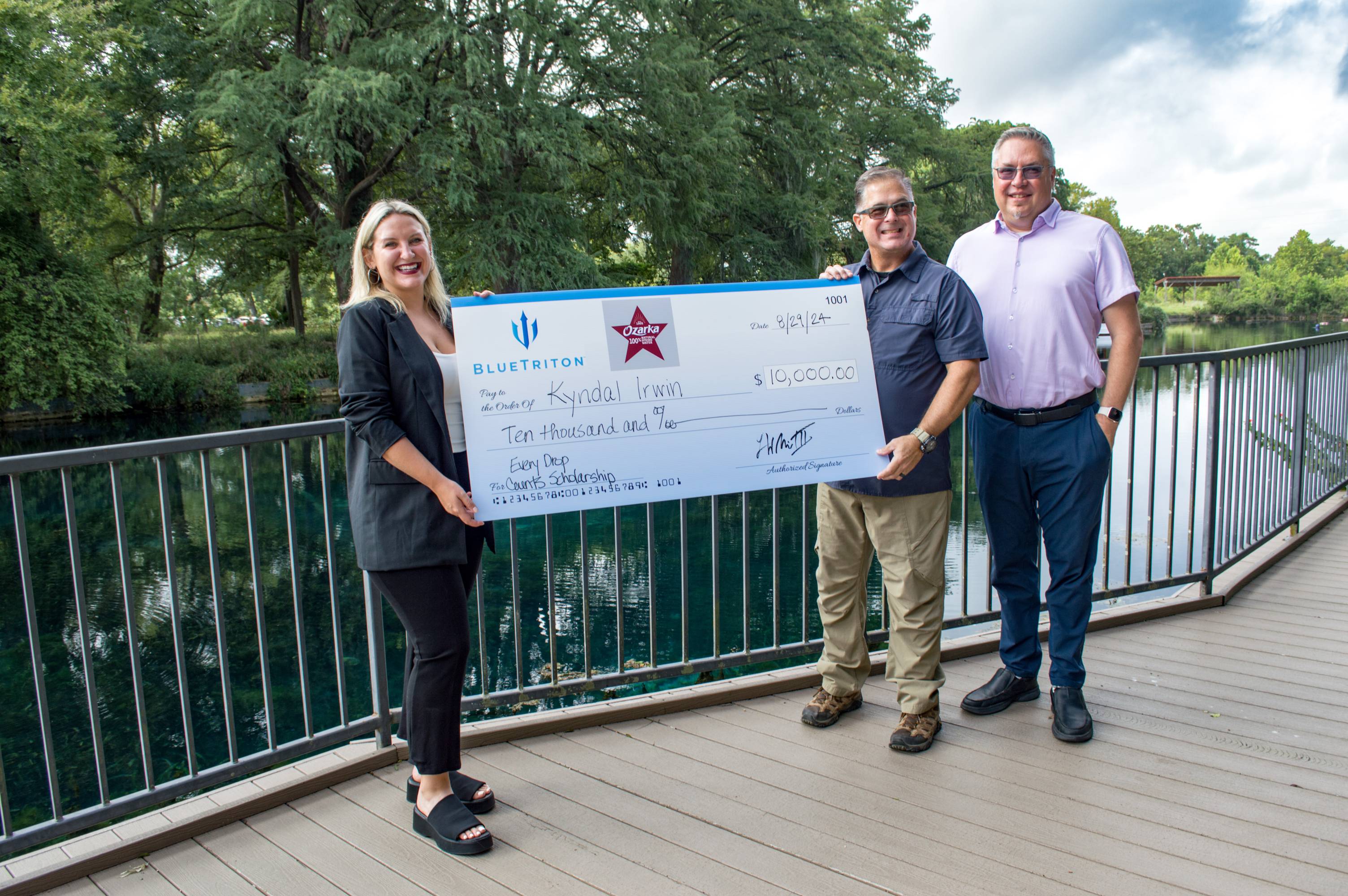 people holding a large signed check