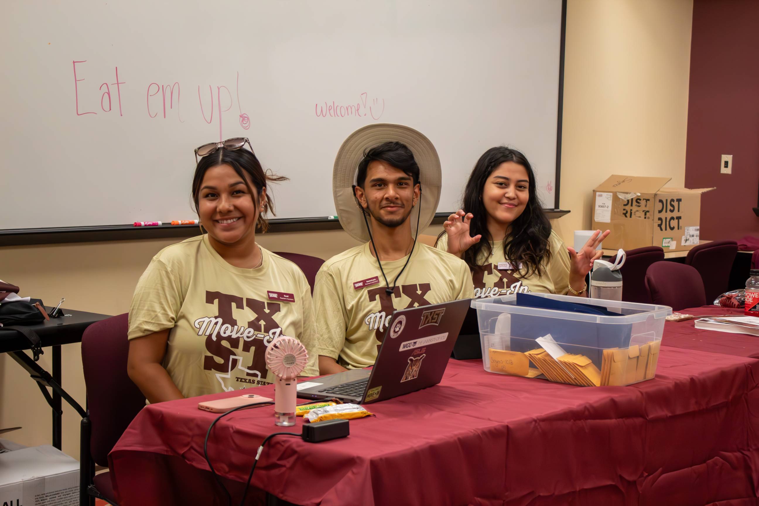 Three RAs at a table during move in