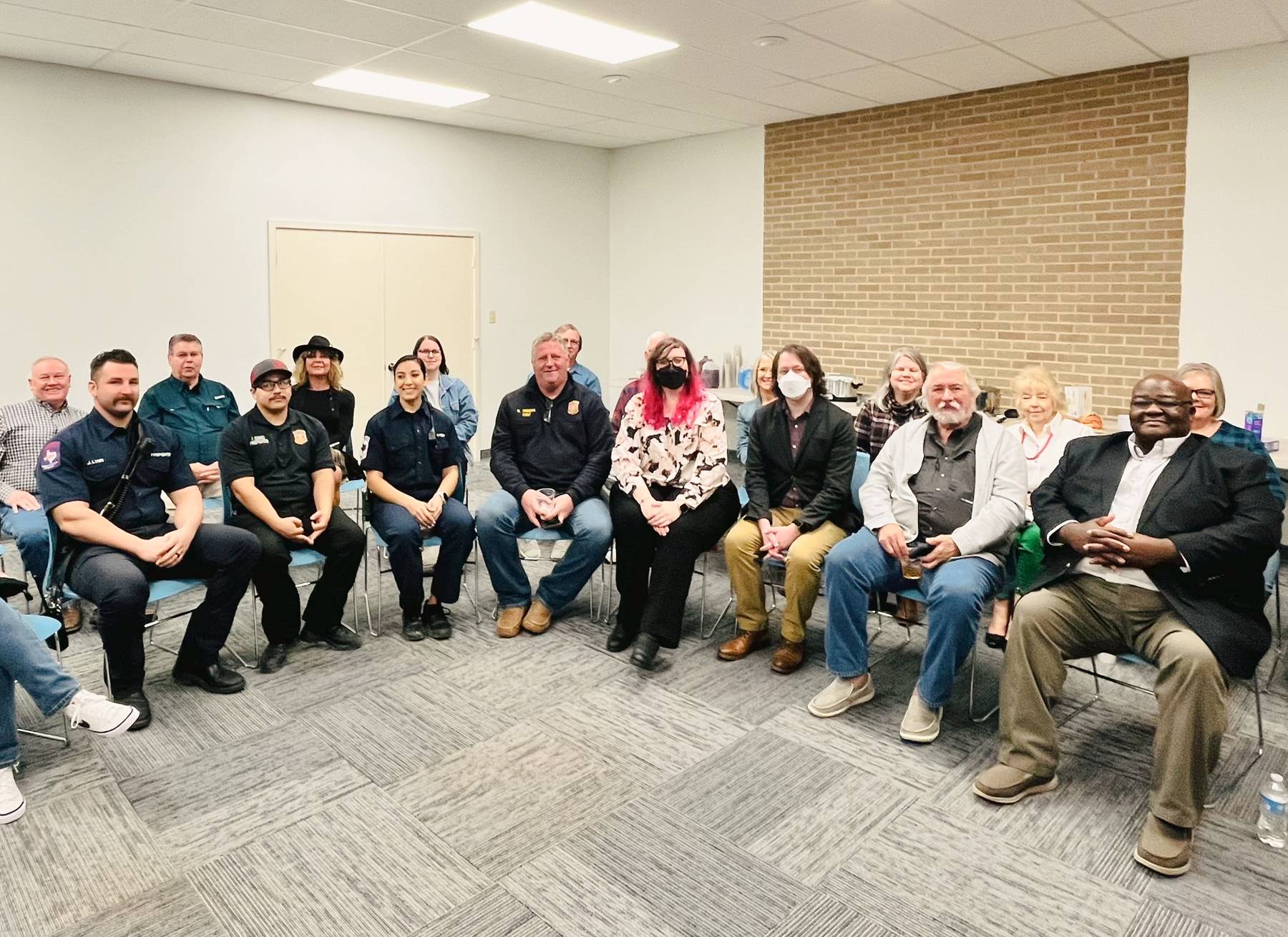 Event facilitators speak with a group of Gladewater community members at the event.