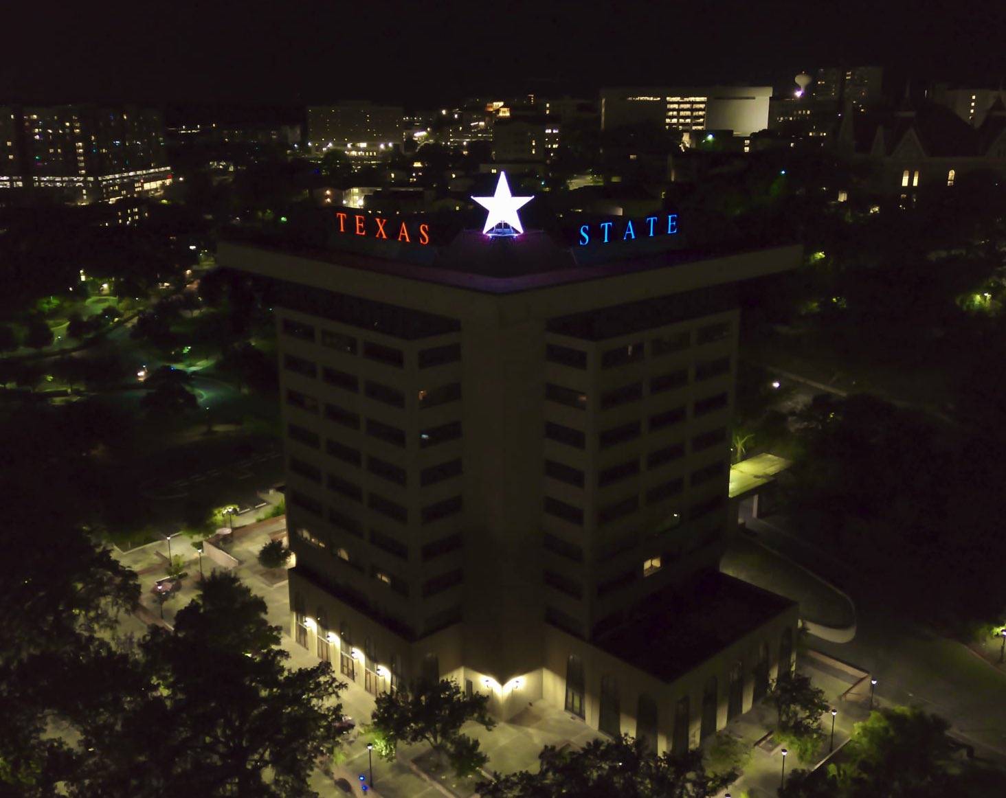 The Victory Star glows on top of the JC Kellam building